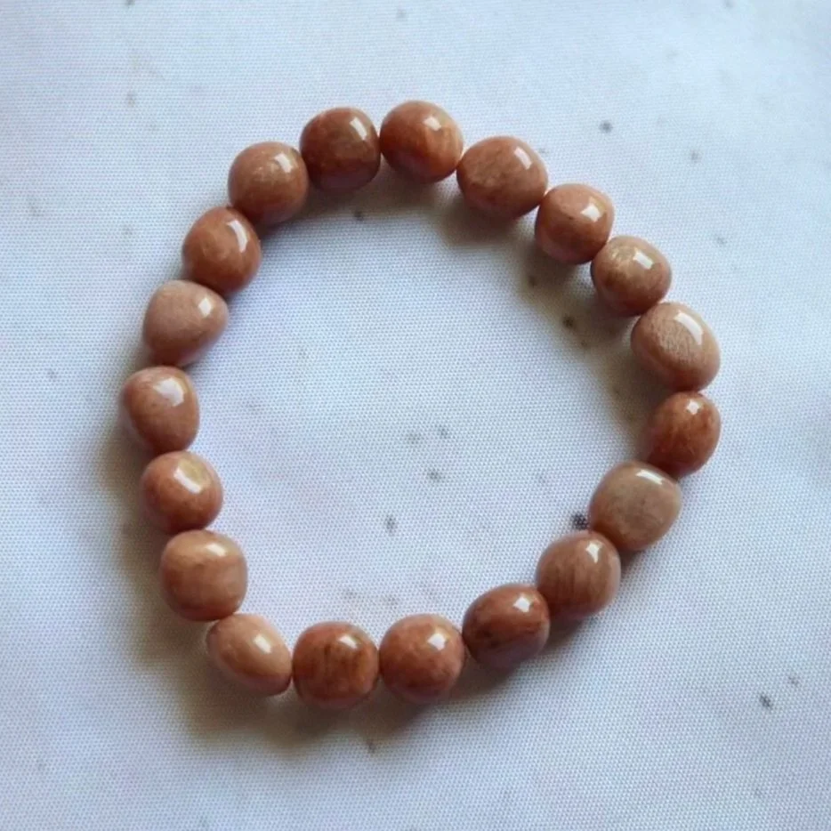 Orange Moonstone tumble bead bracelet with warm peach and cream tones.