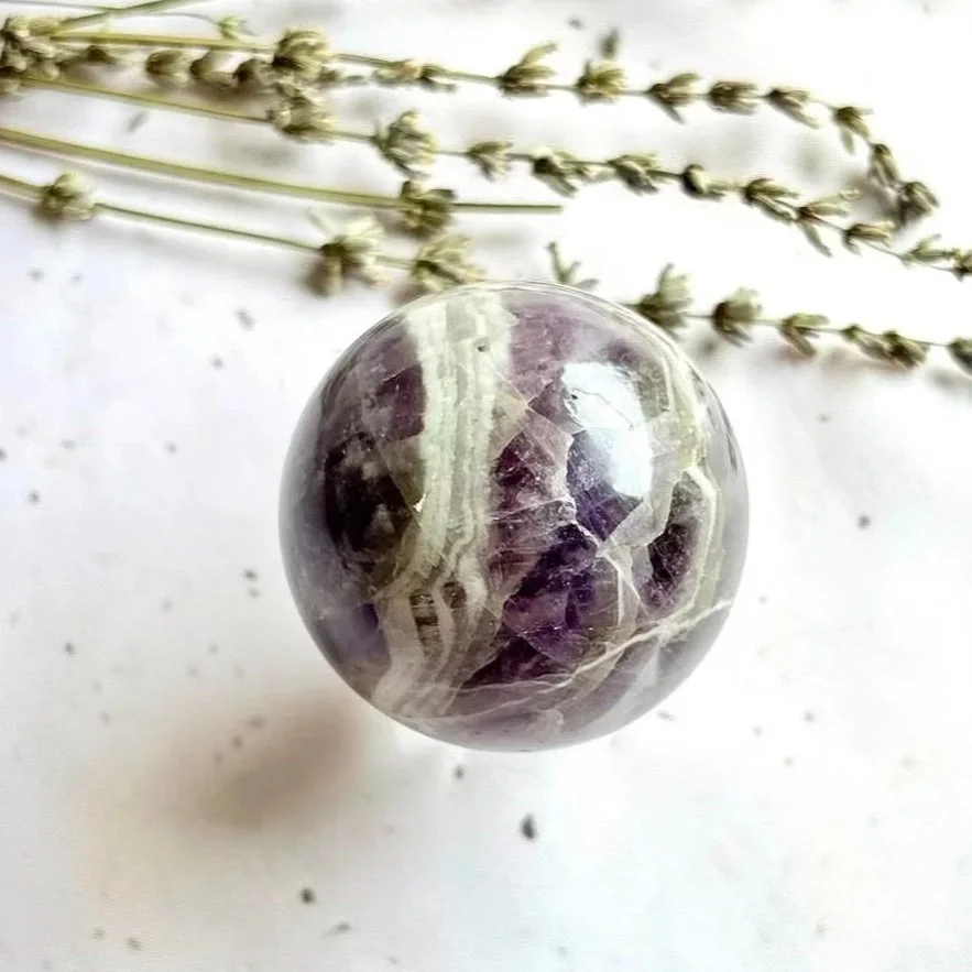 Polished Chevron Amethyst sphere suitable for crystal collections and meditation spaces
