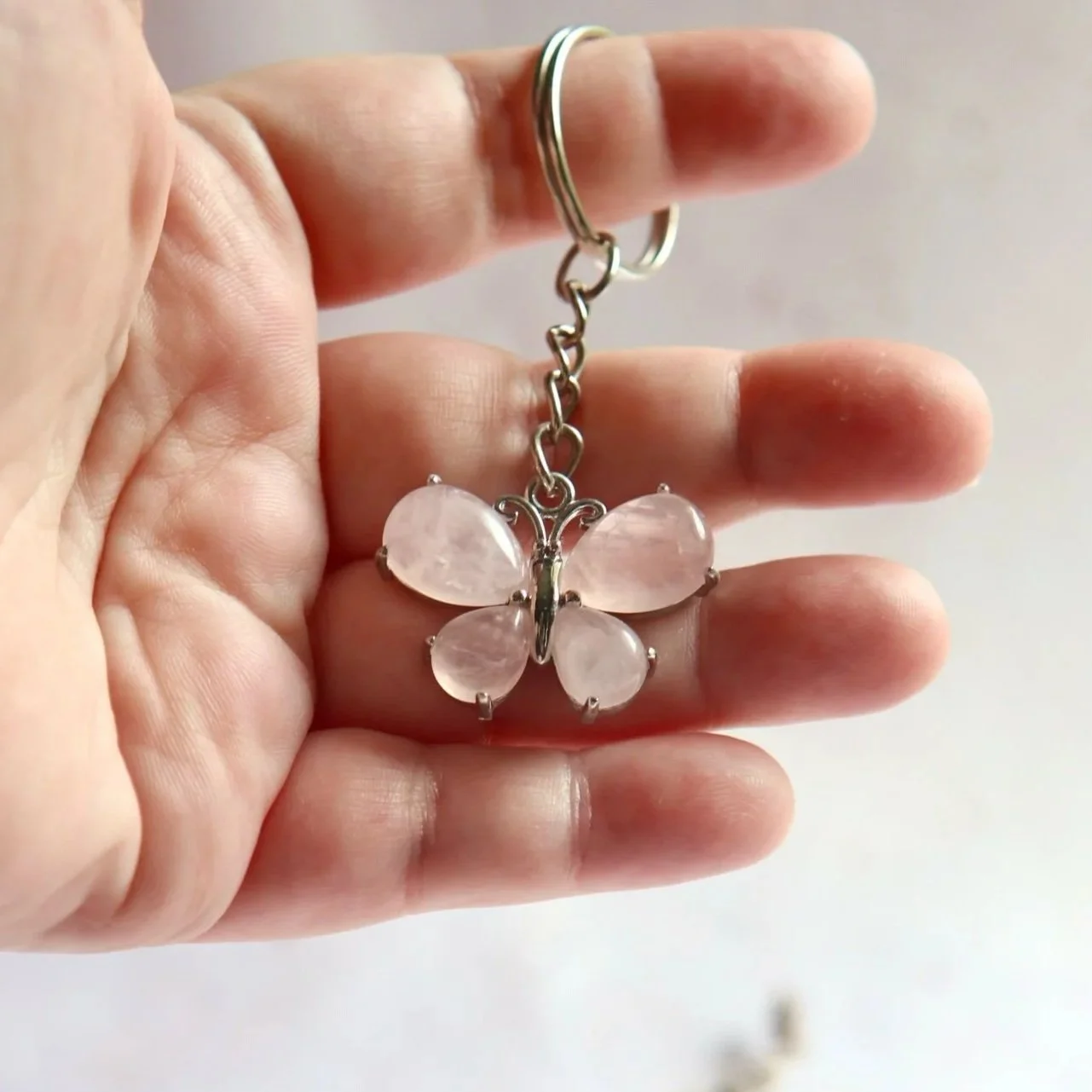 Nature-inspired butterfly keyring made from four teardrop-shaped gemstone cabochons.