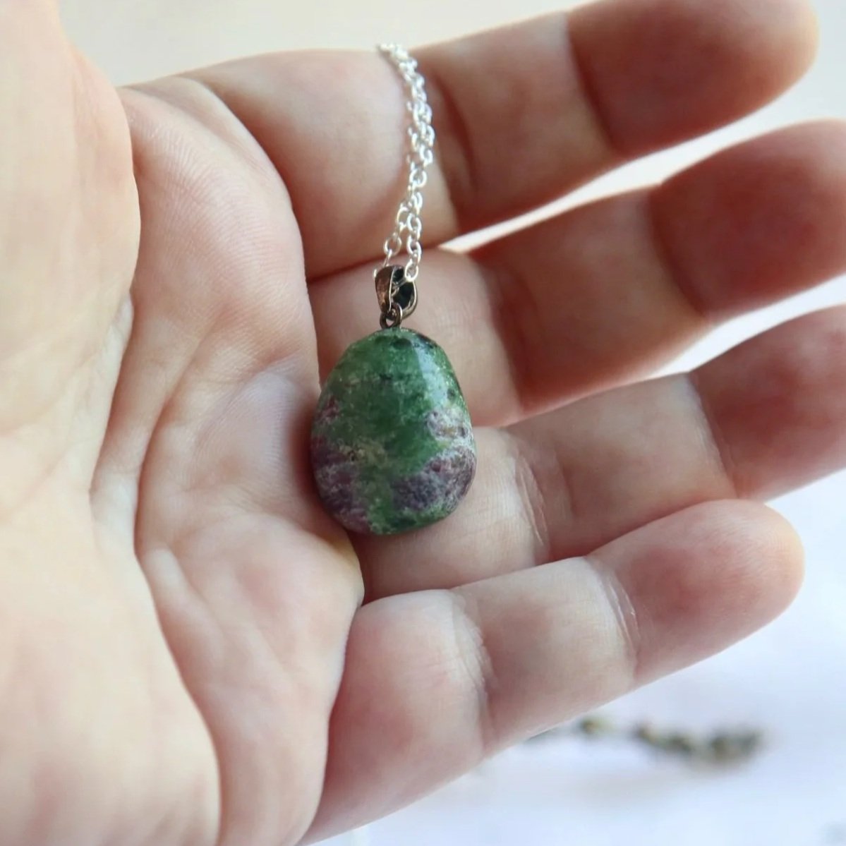 Close-up of a Ruby Zoisite pendant showing its natural green zoisite and red ruby colour contrast.