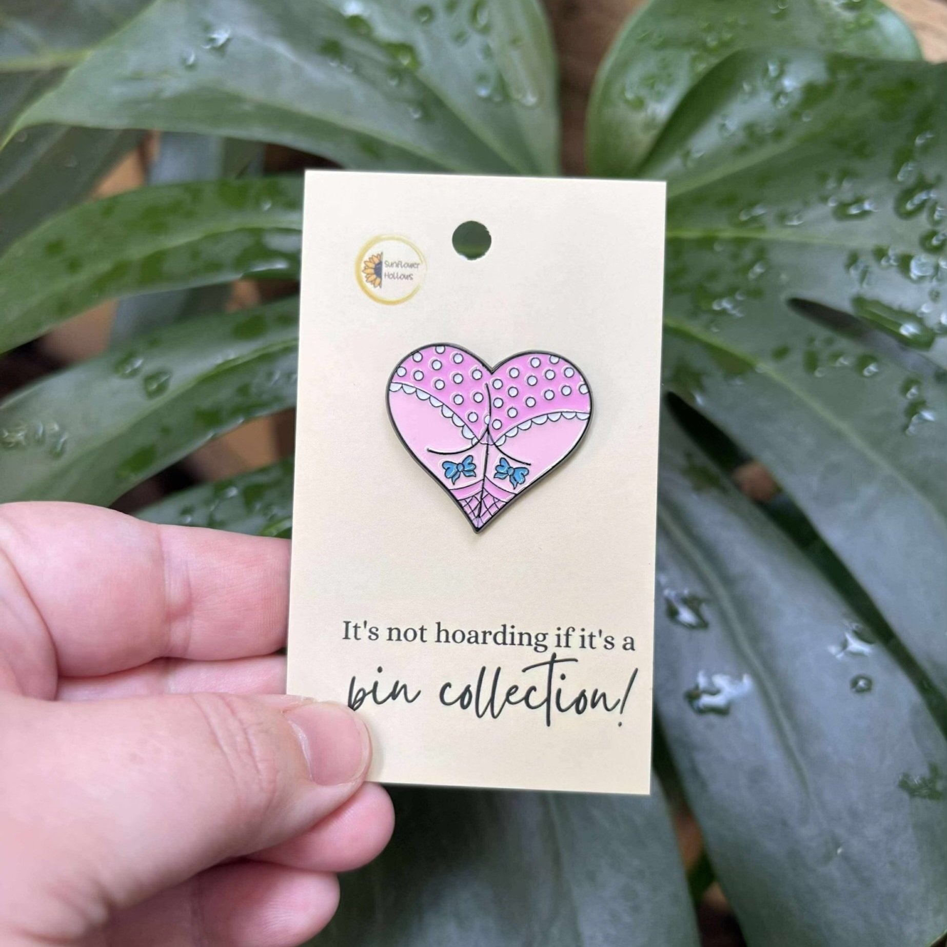 Fun enamel pin showing a cheeky rear inside a heart shape, perfect for playful style