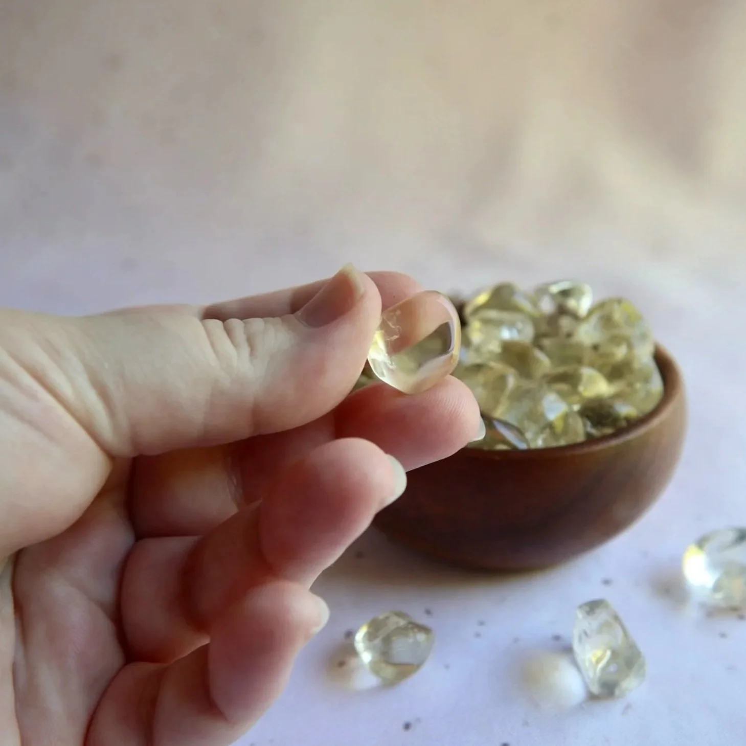 Small Natural Citrine tumble held in hand for scale