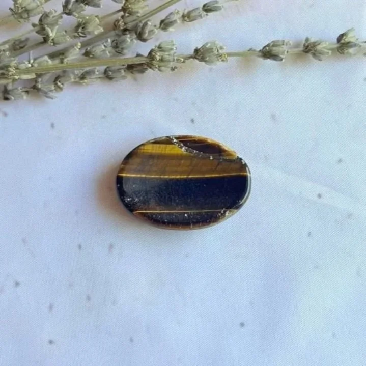 Natural Tiger's Eye oval worry stone with polished finish and thumb indentation