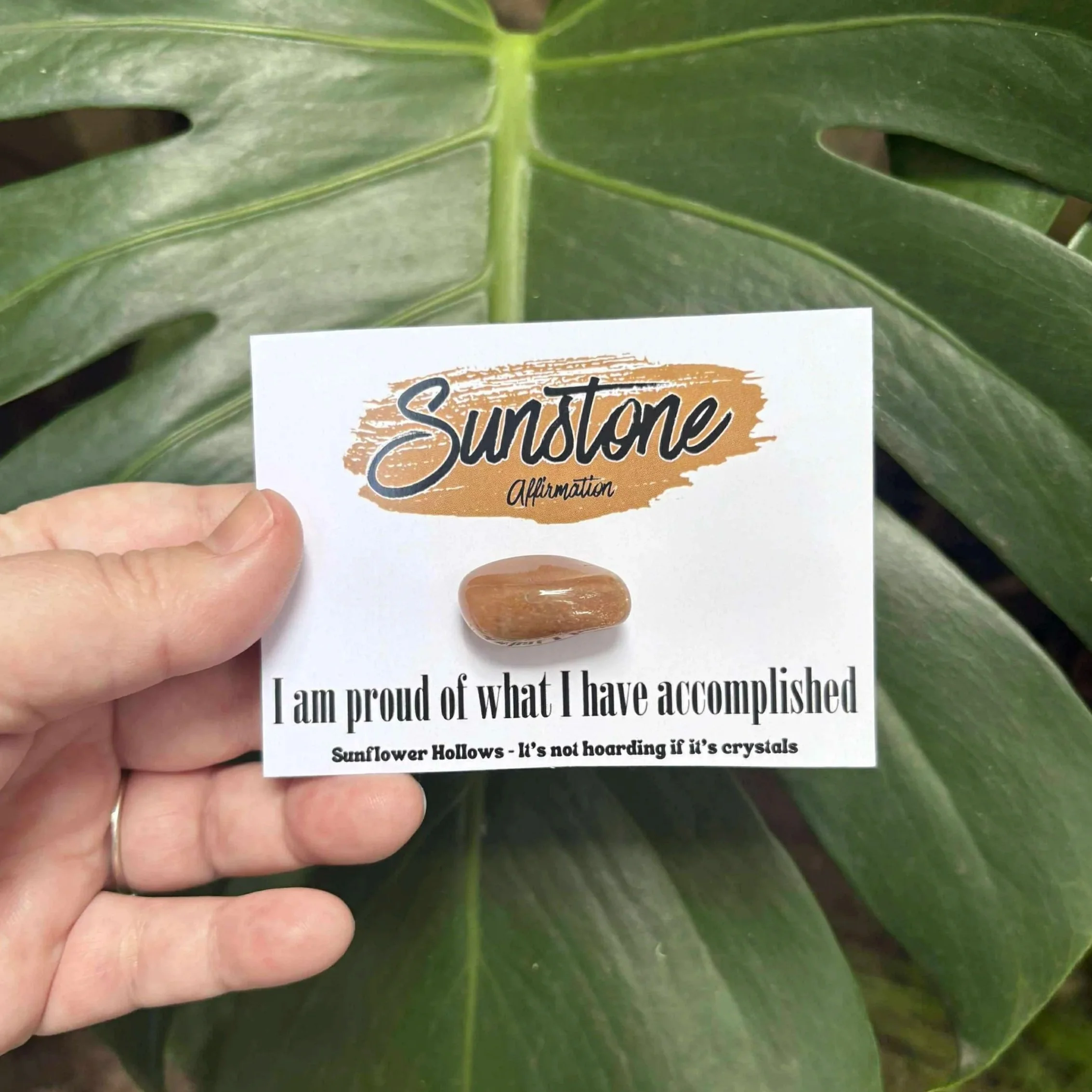 Sunstone crystal with affirmation card that reads “I am proud of what I have accomplished,” designed to inspire confidence and celebrate personal growth.