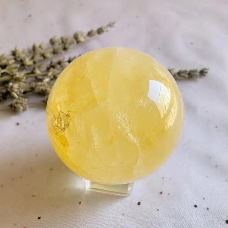Polished Golden Healer Quartz sphere displaying warm golden inclusions