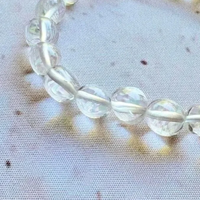Stretch Clear Quartz crystal bracelet displaying transparent and translucent gemstone beads