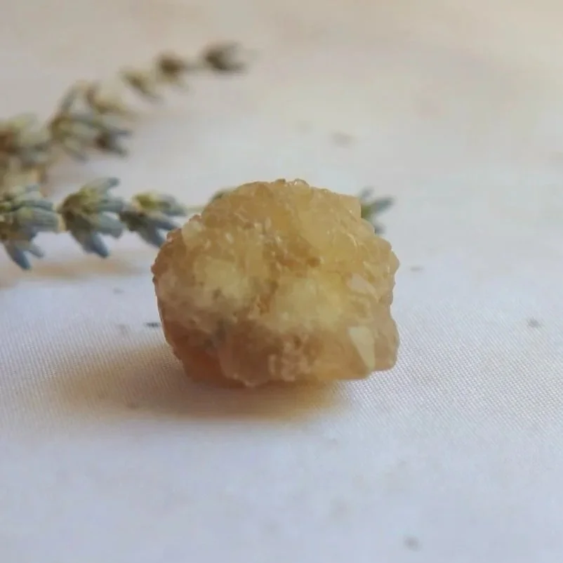 Close-up of a golden natural Citrine crystal with rough natural texture