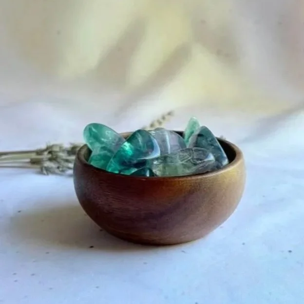 Natural Rainbow Fluorite tumble displaying green, purple, and clear banding with a polished finish