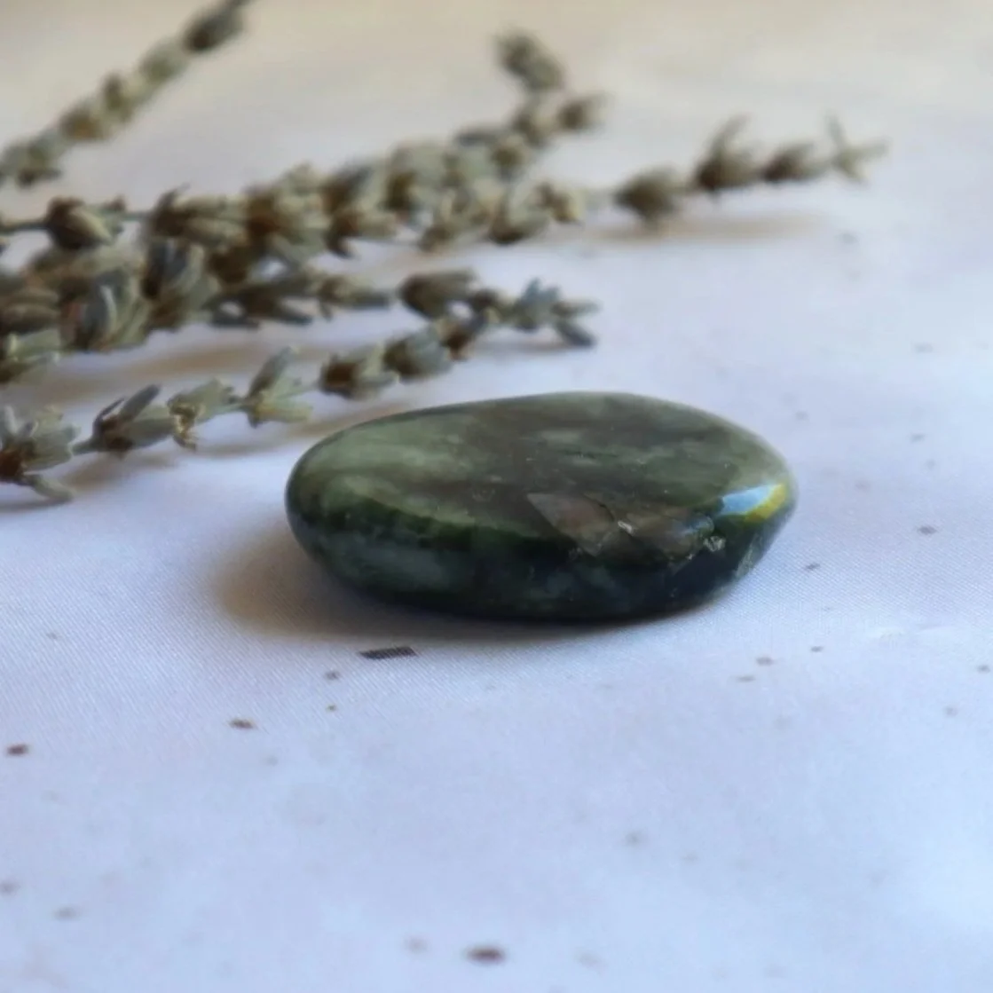 Polished Emerald flat stone with natural variations in colour and markings