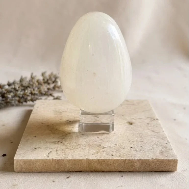 Polished Satin Spar egg, commonly sold as Selenite, displaying natural fibrous chatoyancy and luminous sheen