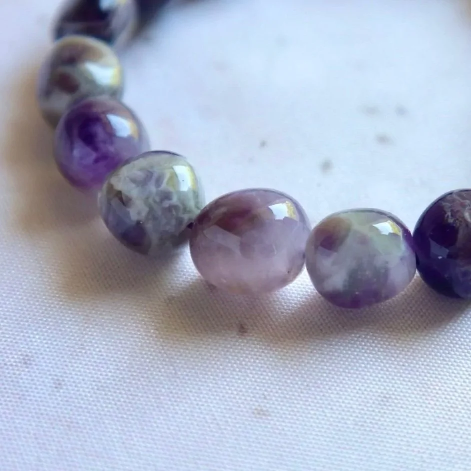 Chevron Amethyst crystal bracelet featuring polished 8–12 mm tumble beads.
