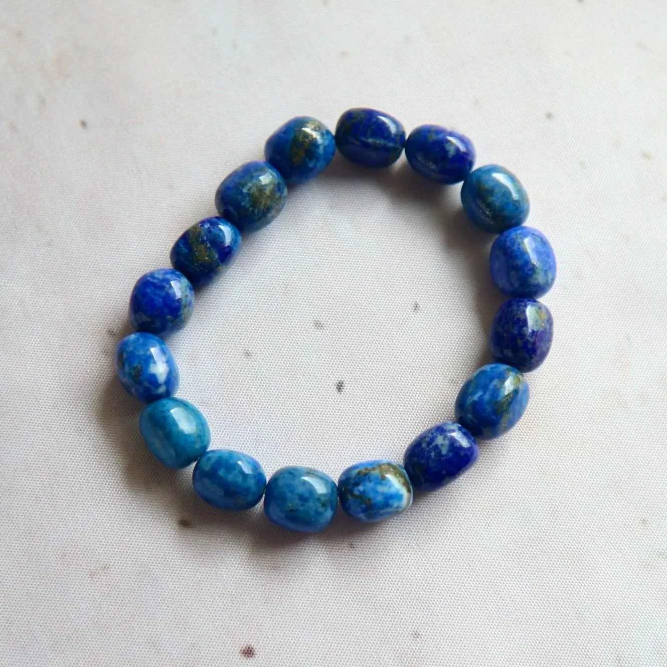 Lapis Lazuli tumble bead bracelet featuring smooth polished beads with rich blue colouring and natural golden flecks
