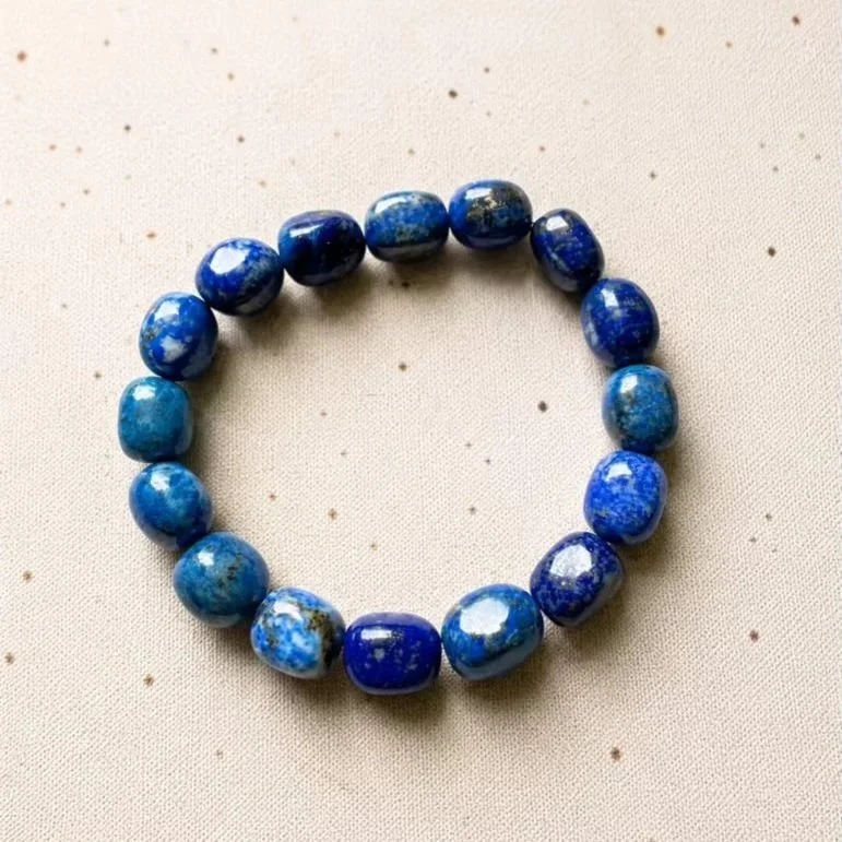Lapis Lazuli crystal bracelet with polished 8-12mm tumble beads displaying rich royal blue tones and natural mineral inclusions.