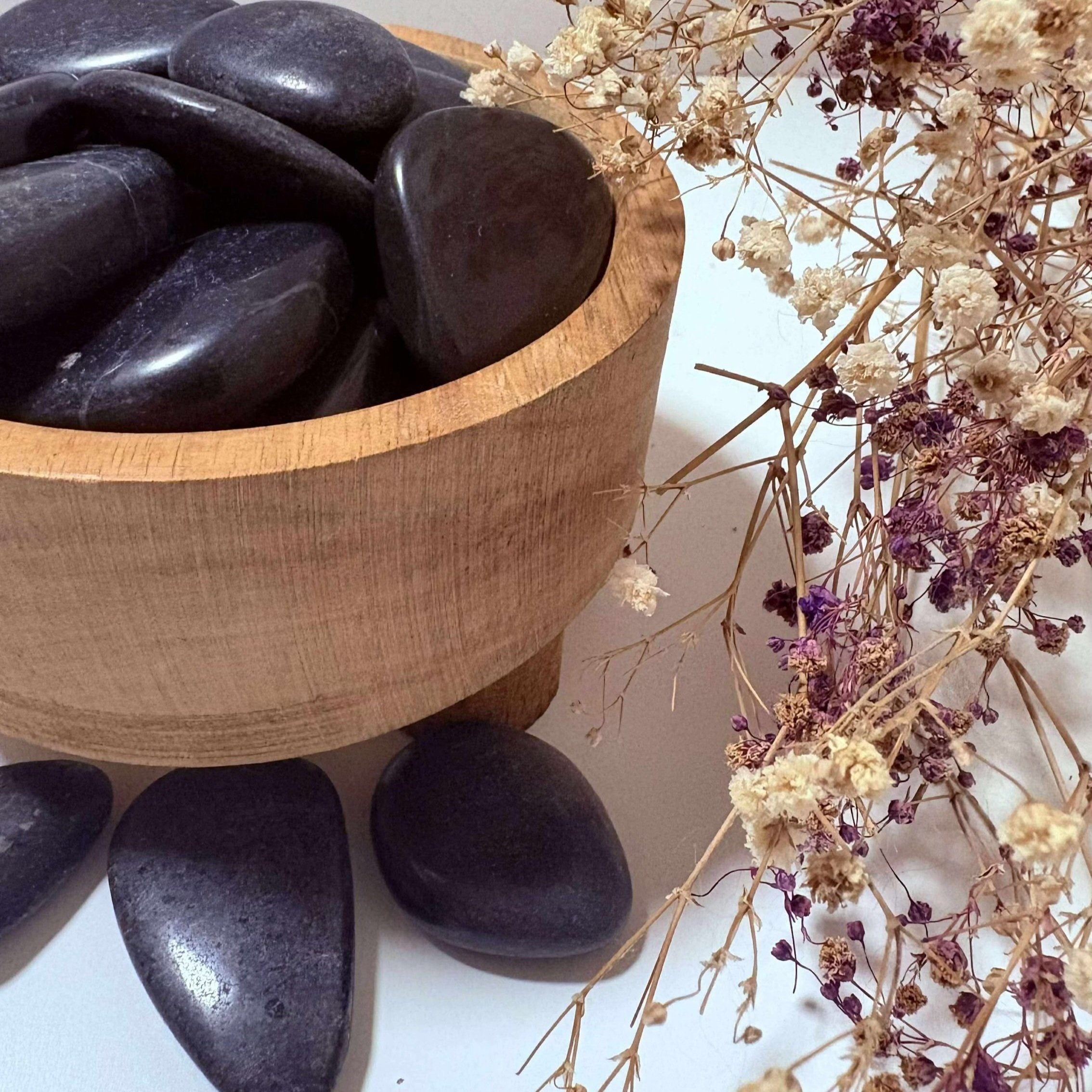 Smooth Black Onyx palm stone, ideal for inner strength and emotional stability