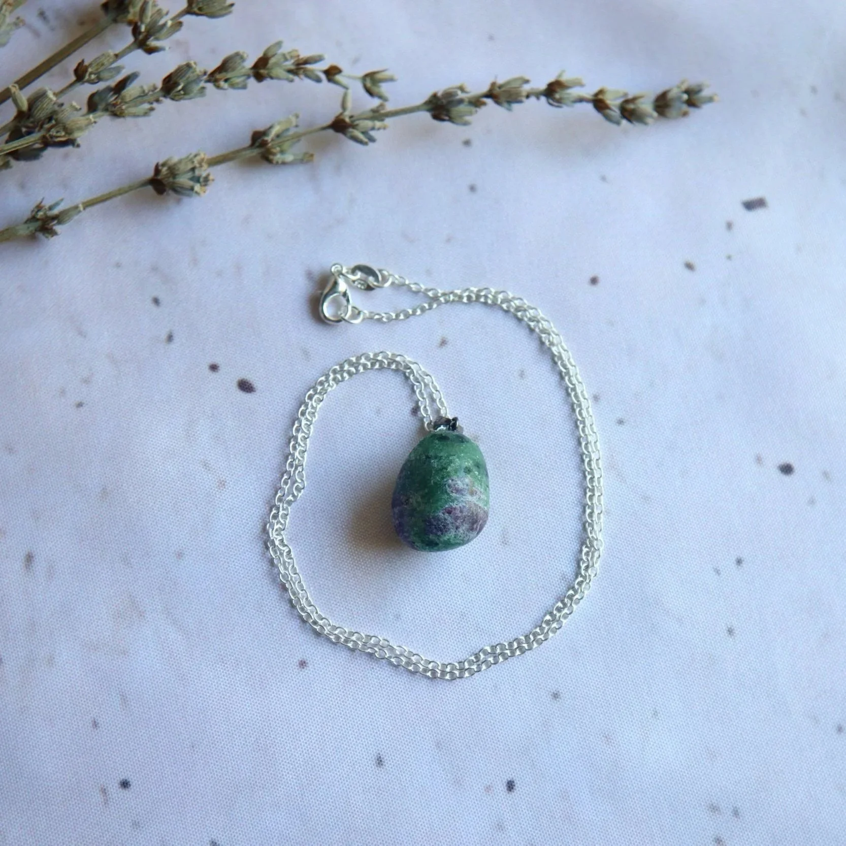 Ruby Zoisite gemstone pendant in an organic egg-shaped design, selected for its distinctive natural colour pattern.