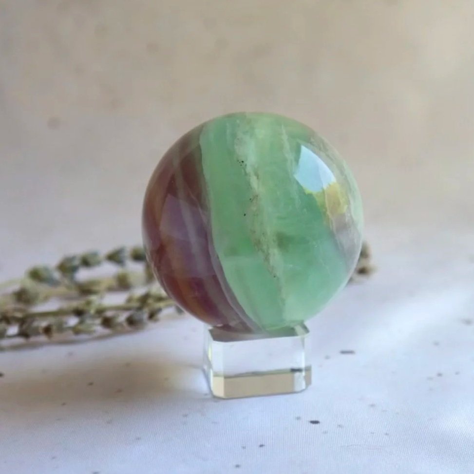 Fluorite crystal sphere measuring approximately 5.4cm in diameter