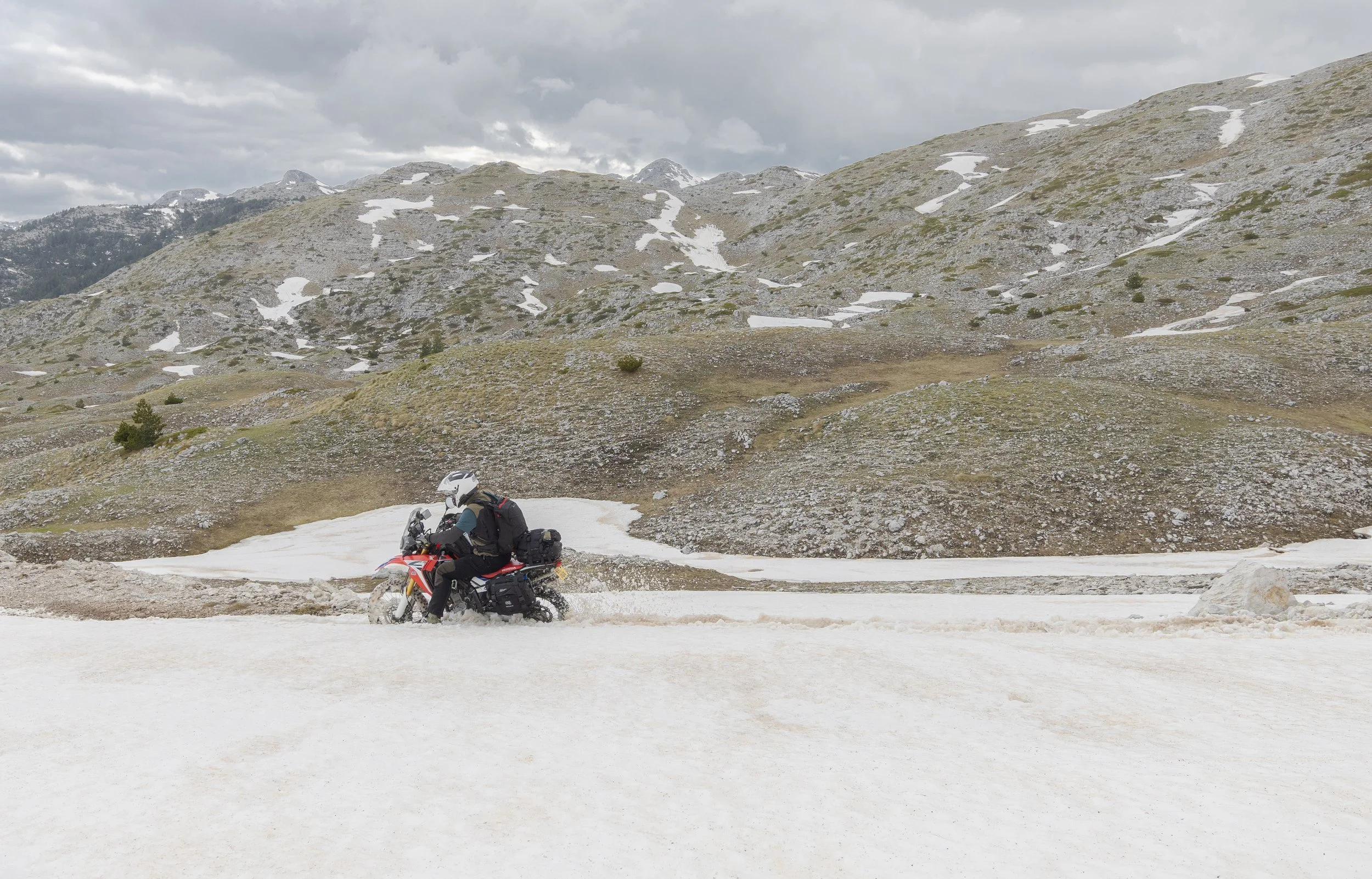 Jim wades his way through a snow filled mountain pass. Montenegro. 2026. 