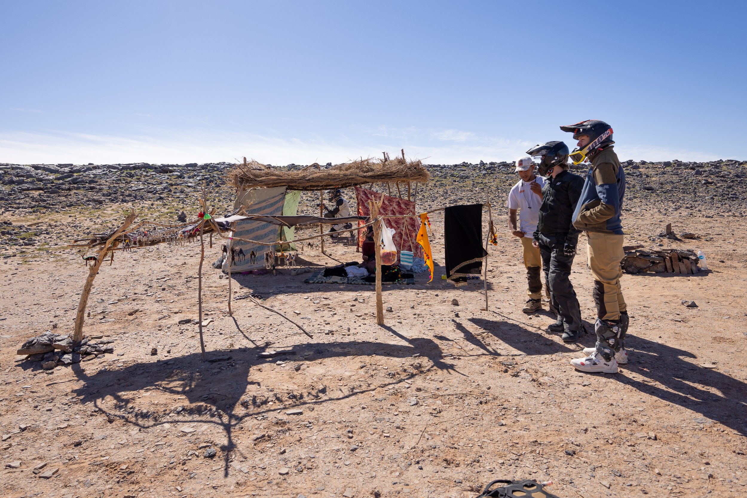 Occasionally small shacks emerge in the barren landscape. Whilst they feel incredibly remote, they are actually located on what is a well used moto-tourism dirt track. The team stop and take a minute to see what is on offer, and pick up some souvenir