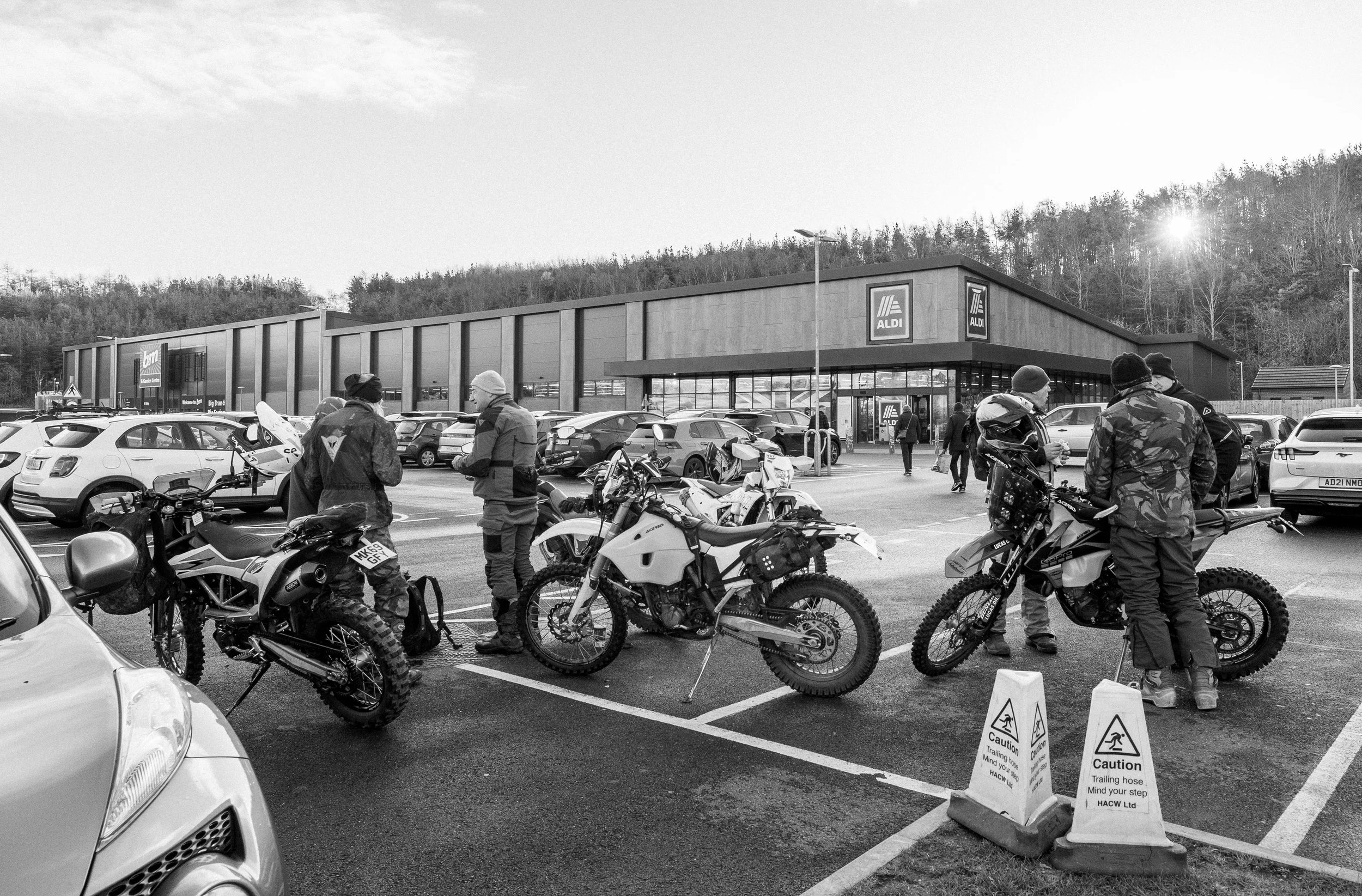 The TRF crew gather for the compulsory pre-ride bacon roll and cup of tea in Prudhoe. Riders had travelled from Tynemouth and Carlisle to meet up for the days ride. Northumberland, England. 2024. 