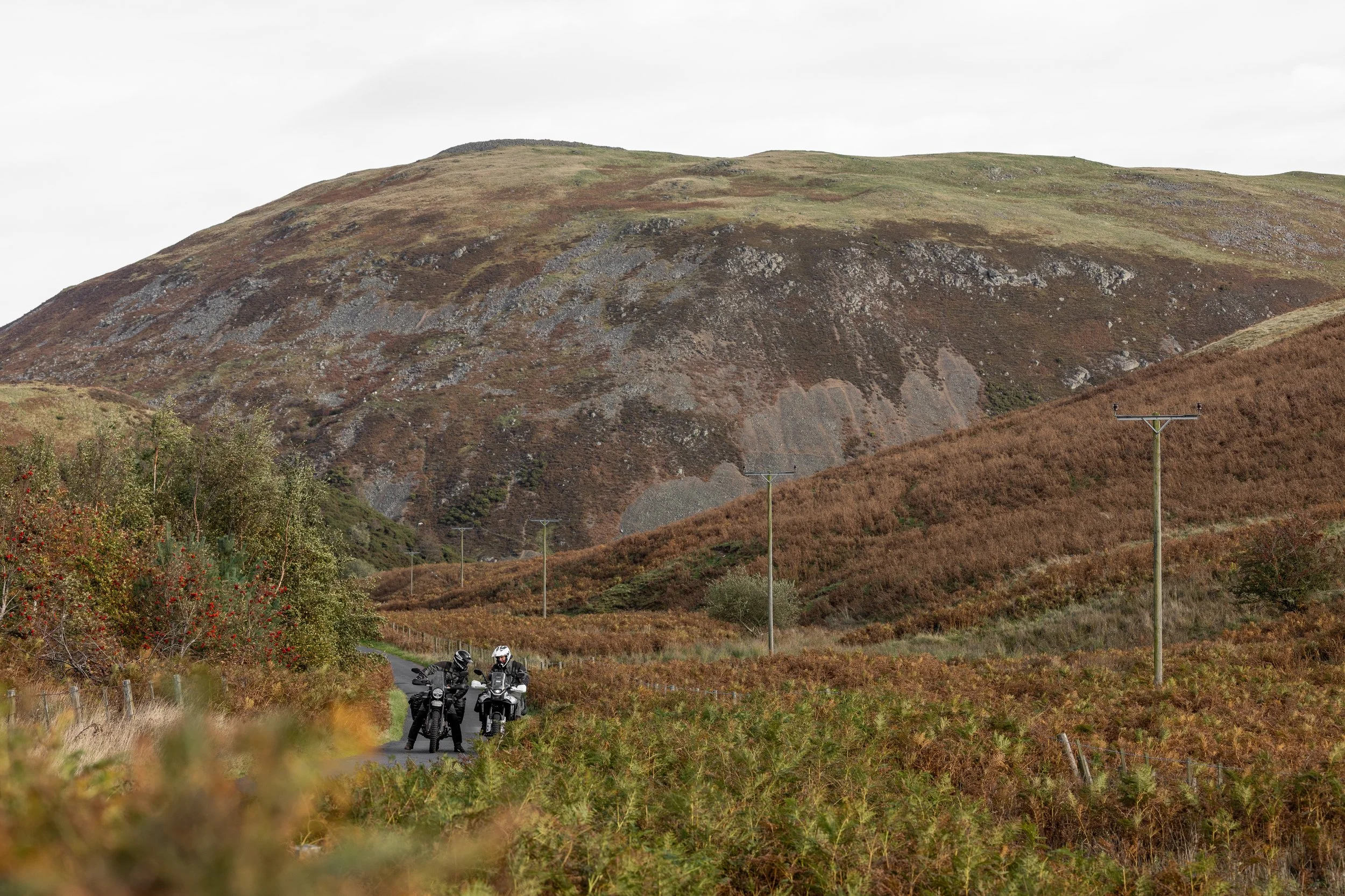 Chris and Jim check the route on the road to Linhope Spout, Northumberland. England. 2025.