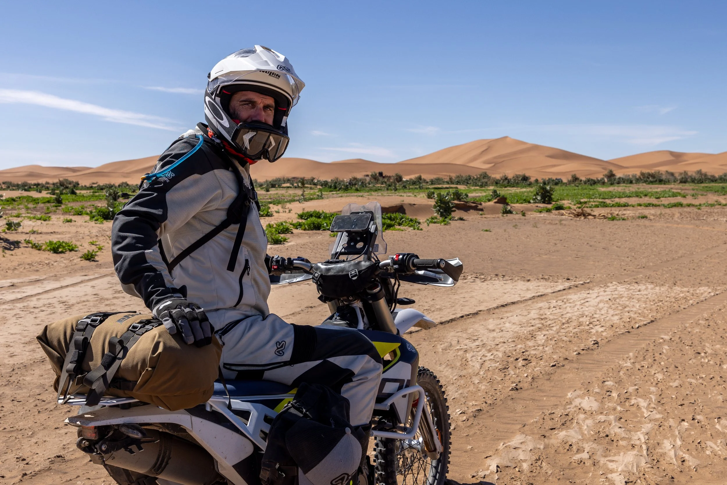 Under that helmet is a huge smile as Jim pauses on the edge of Erg Chegaga. The dunes rise out of the flat lake bed and are a playground for moto enthusiasts. The tallest are an extreme challenge of man and machine to get to the top of.