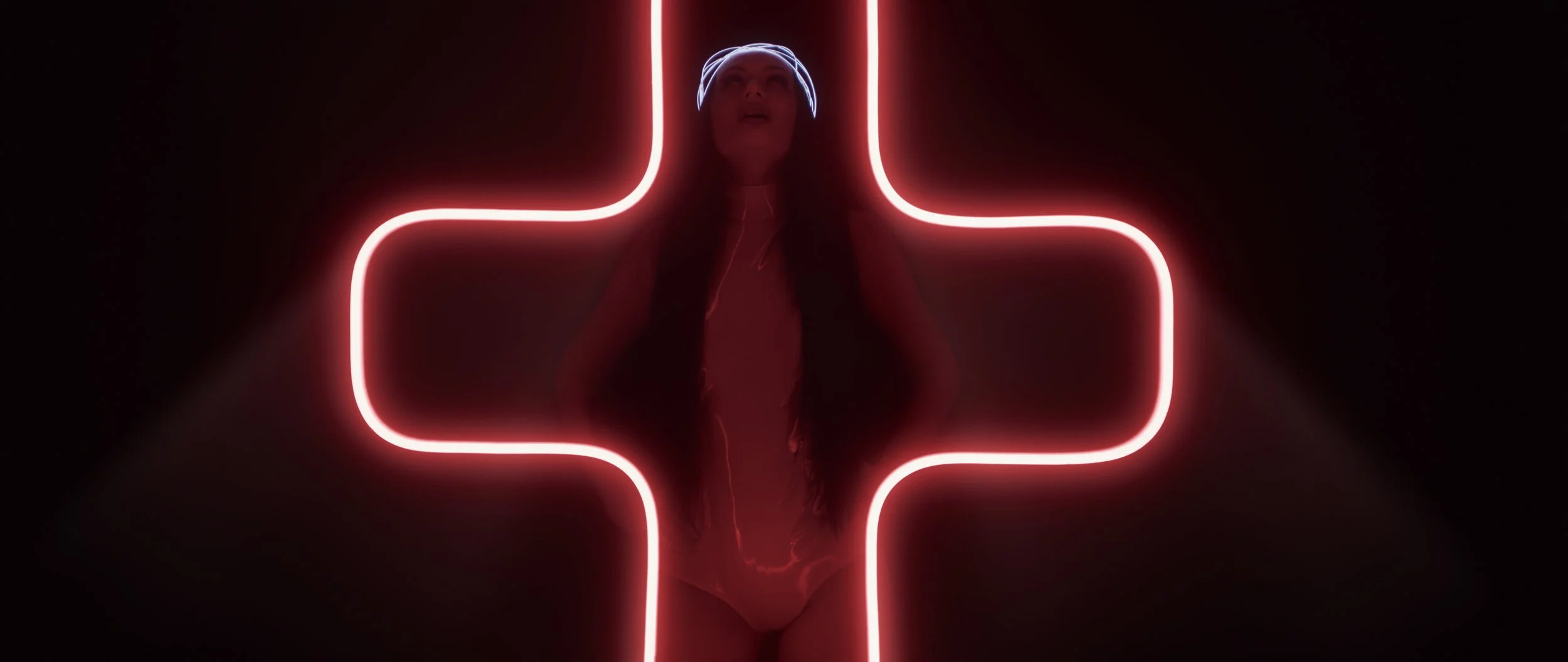 woman standing behind red crucifix