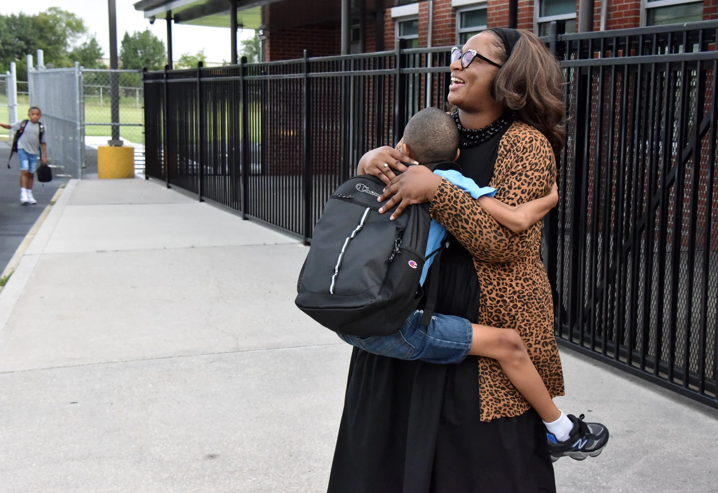parent-carrying-child-first-day-drop-off.jpg