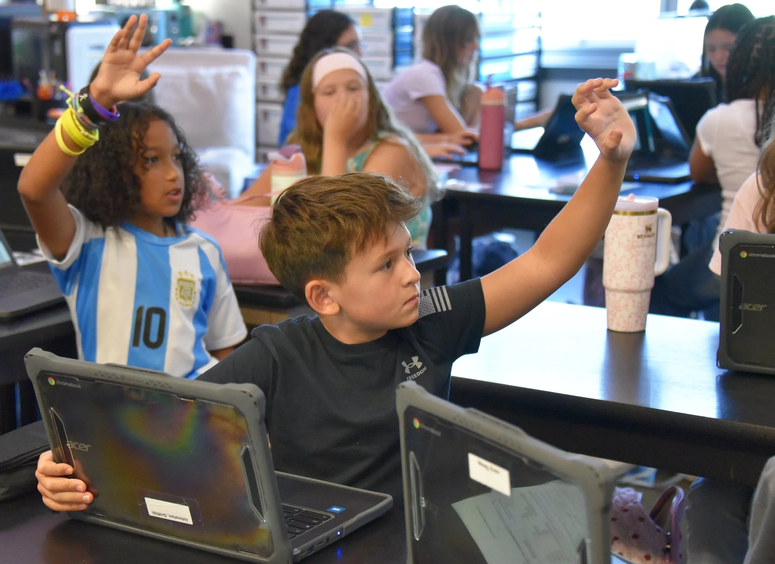 students-raising-hands-with-chromebooks.jpg
