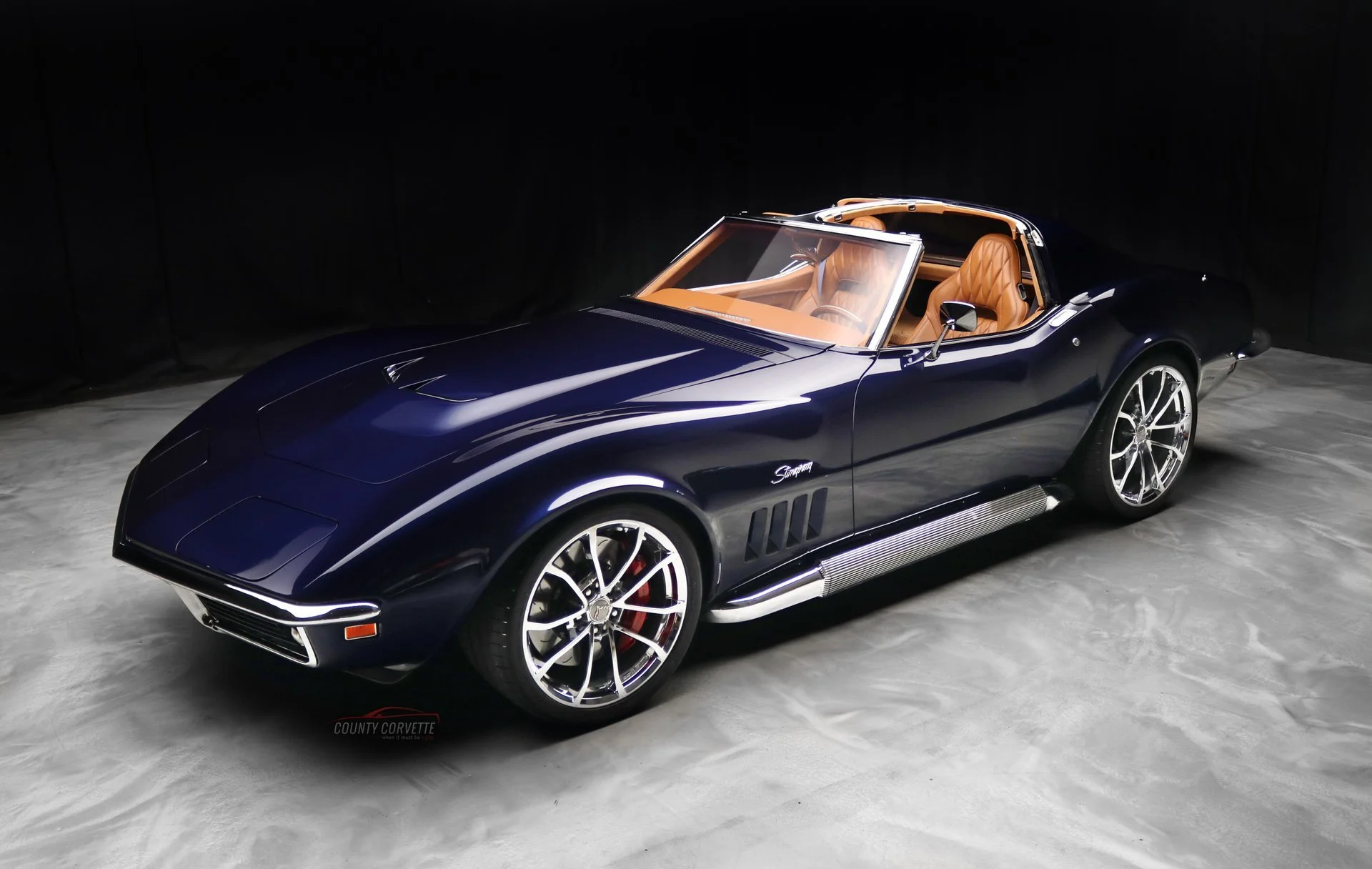 1969 Corvette Restomod with blue metallic paint and a tan leather interior