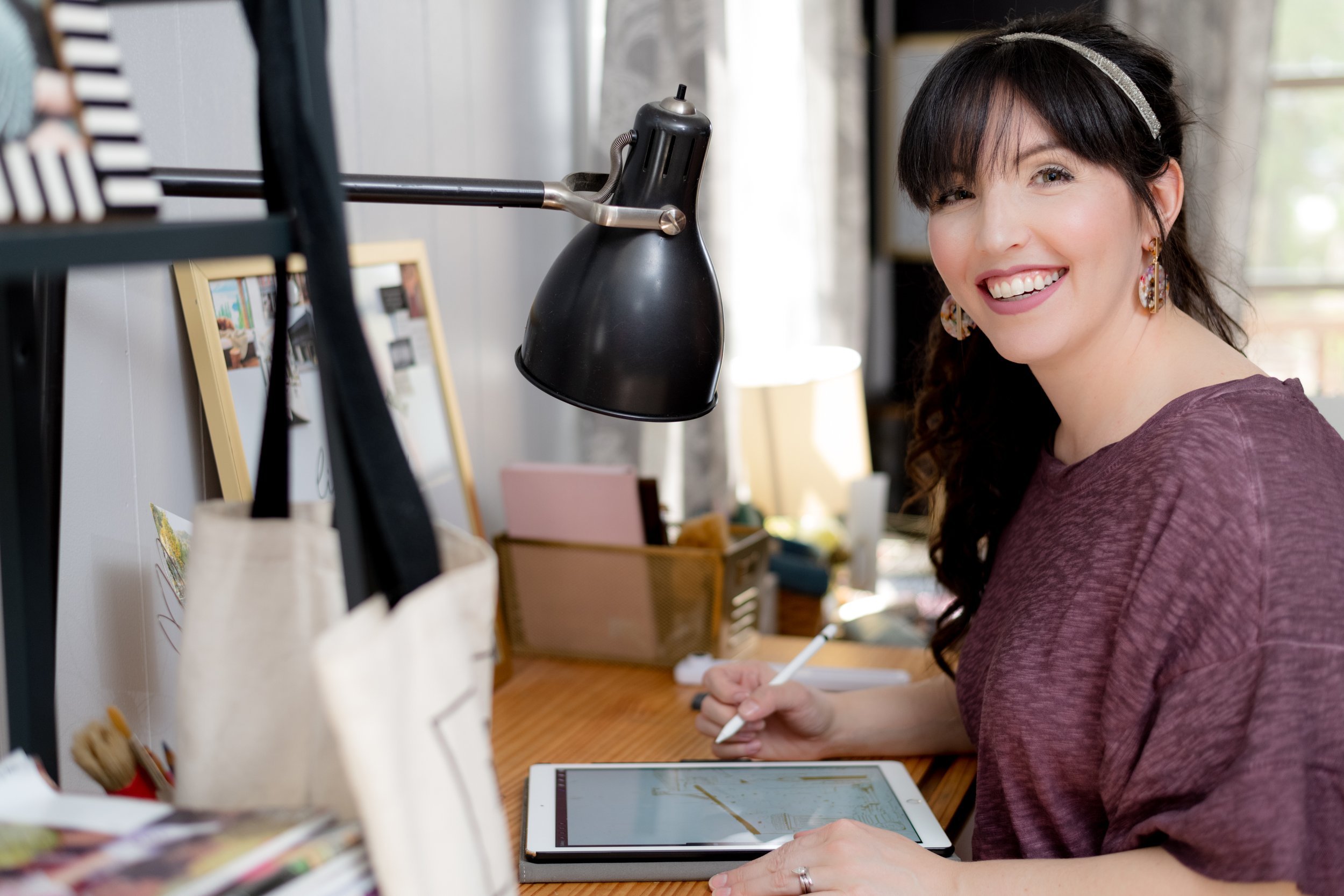 A portrait of the woman smiling warmly, portraying her friendly and approachable demeanor in a professional setting.