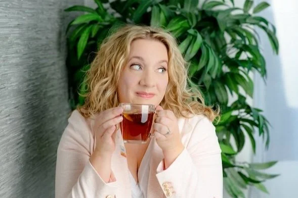 Personal branding headshot of a woman holding a cup of tea