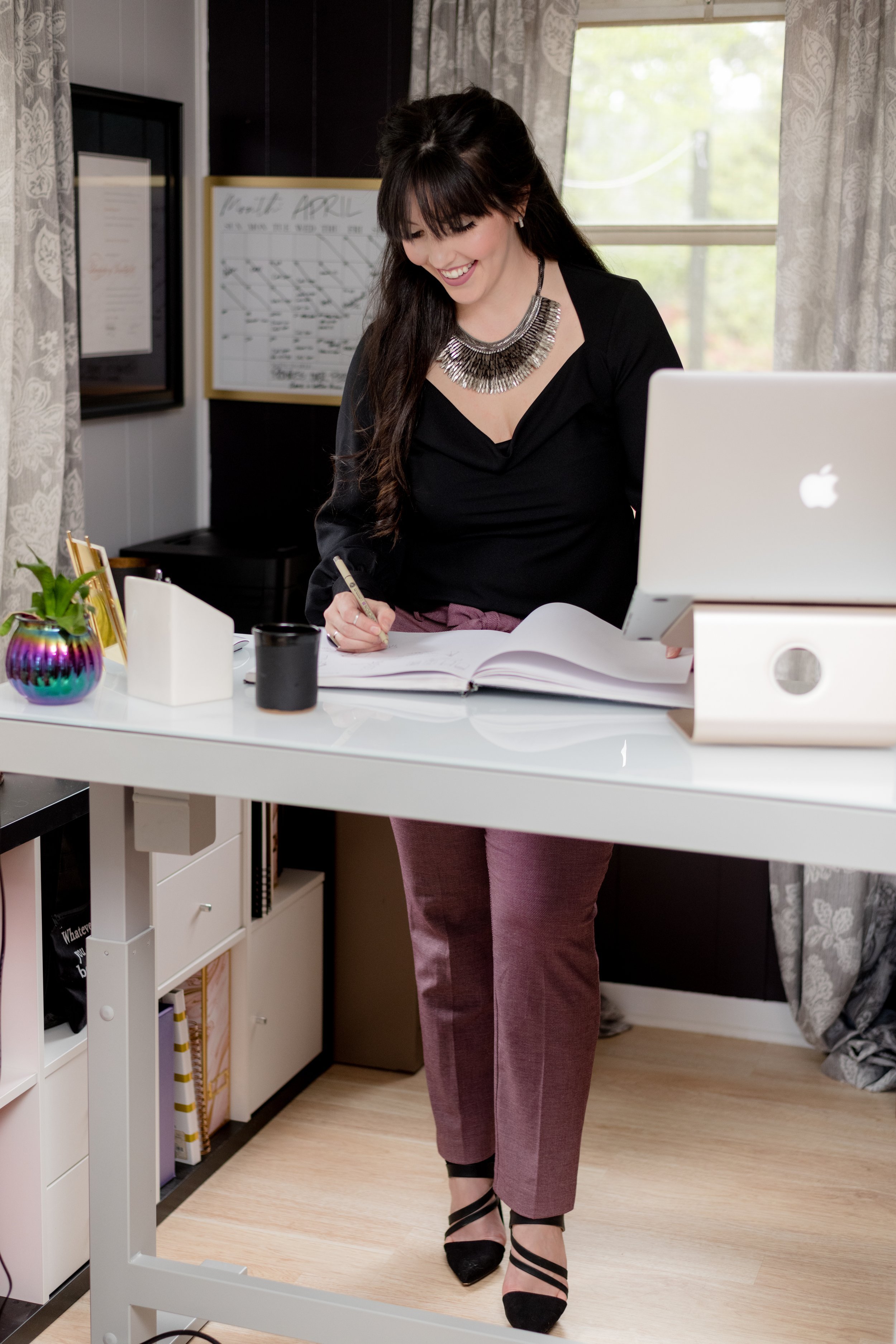 A candid photo capturing the woman intently working on her computer, highlighting her dedication and productivity skills.
