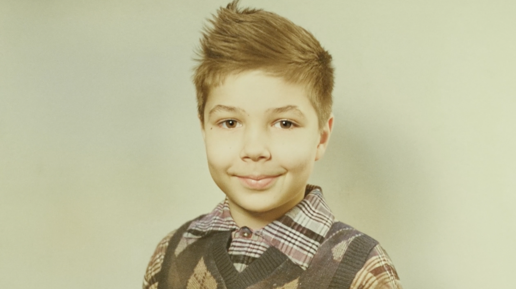 Vintage childhood portrait from a family archive, used in a custom biography documentary to preserve early life history.