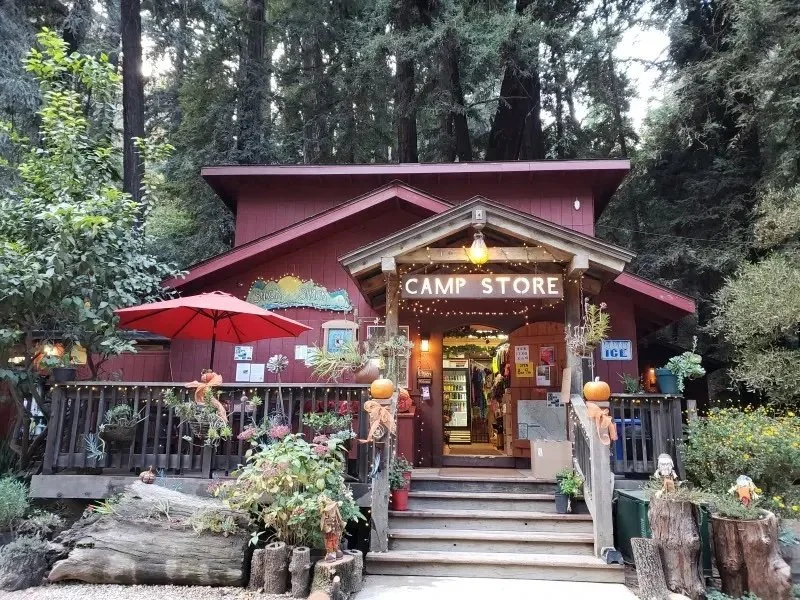 Camp store at Riverside Campgrounds and Cabins. Red building with string lights.