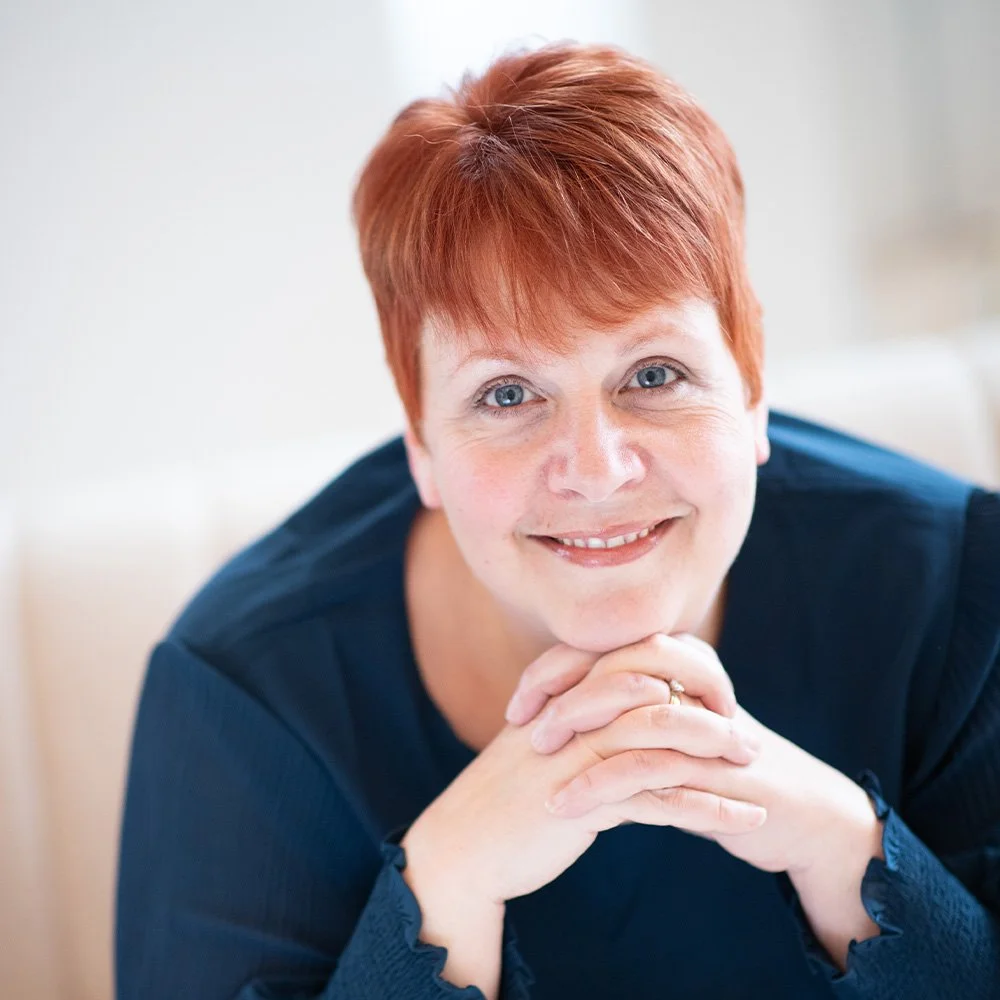 Dr. Anna Stumpf, leadership coach, smiling warmly, offering personalized coaching for emotional intelligence development, stress management, and team performance improvement.