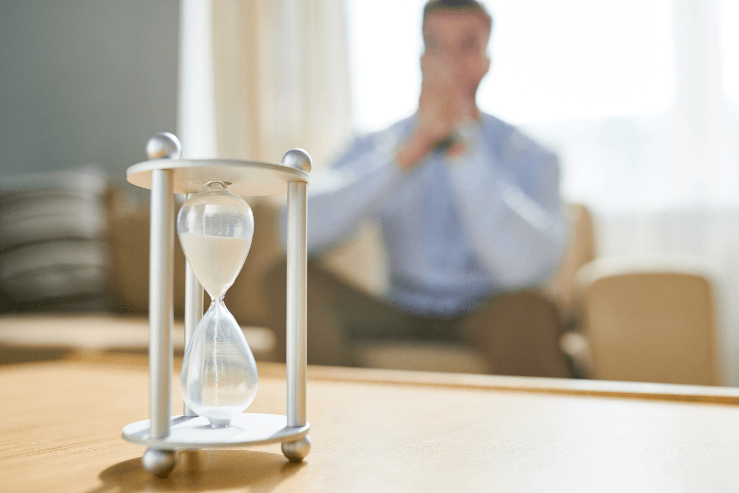 the passive waiter job seeker, sitting down with a timer signifying time flying as the job seeker waits to take action in his job search