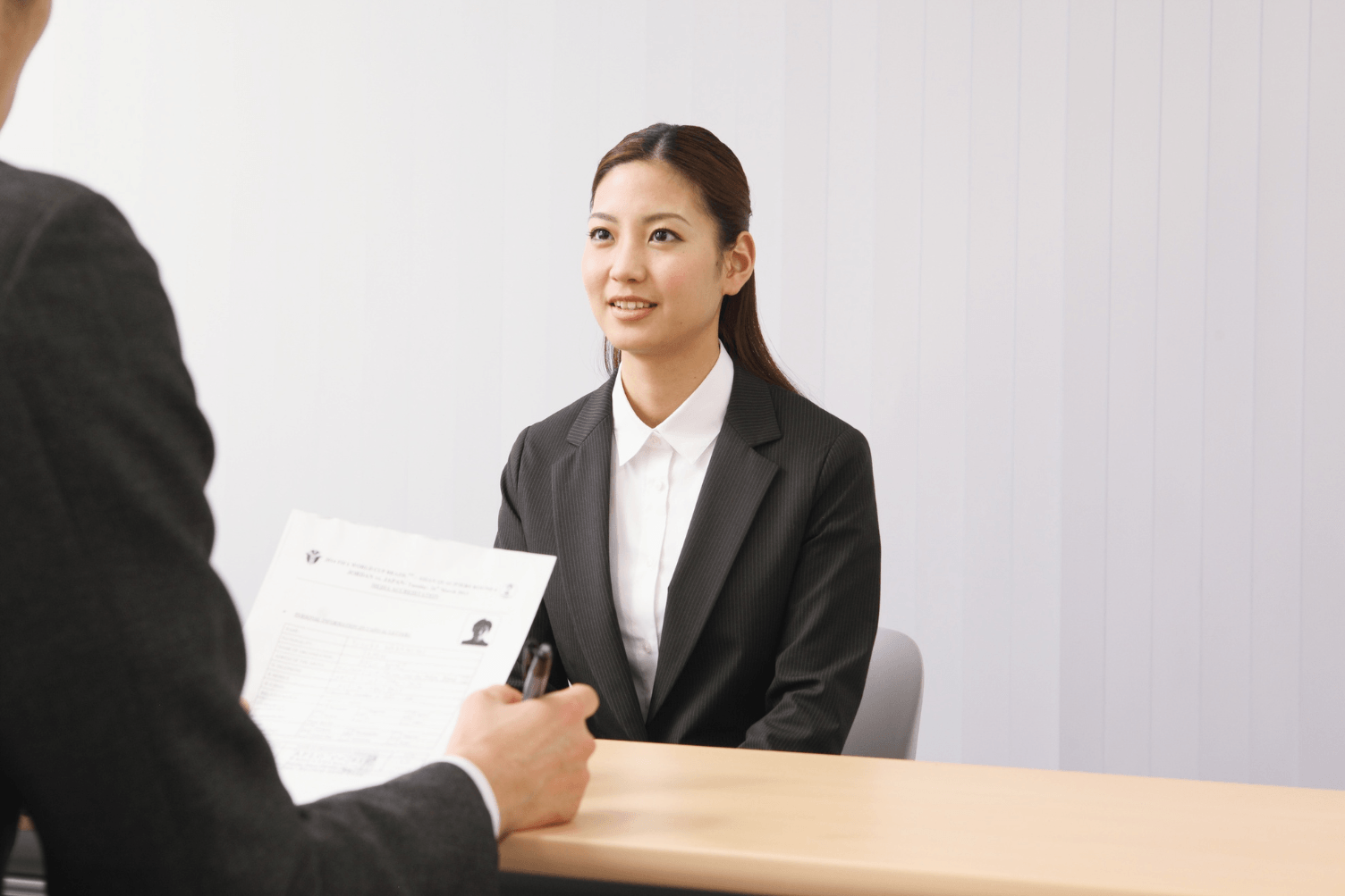 women professional sitting in a room been interview by recruiter