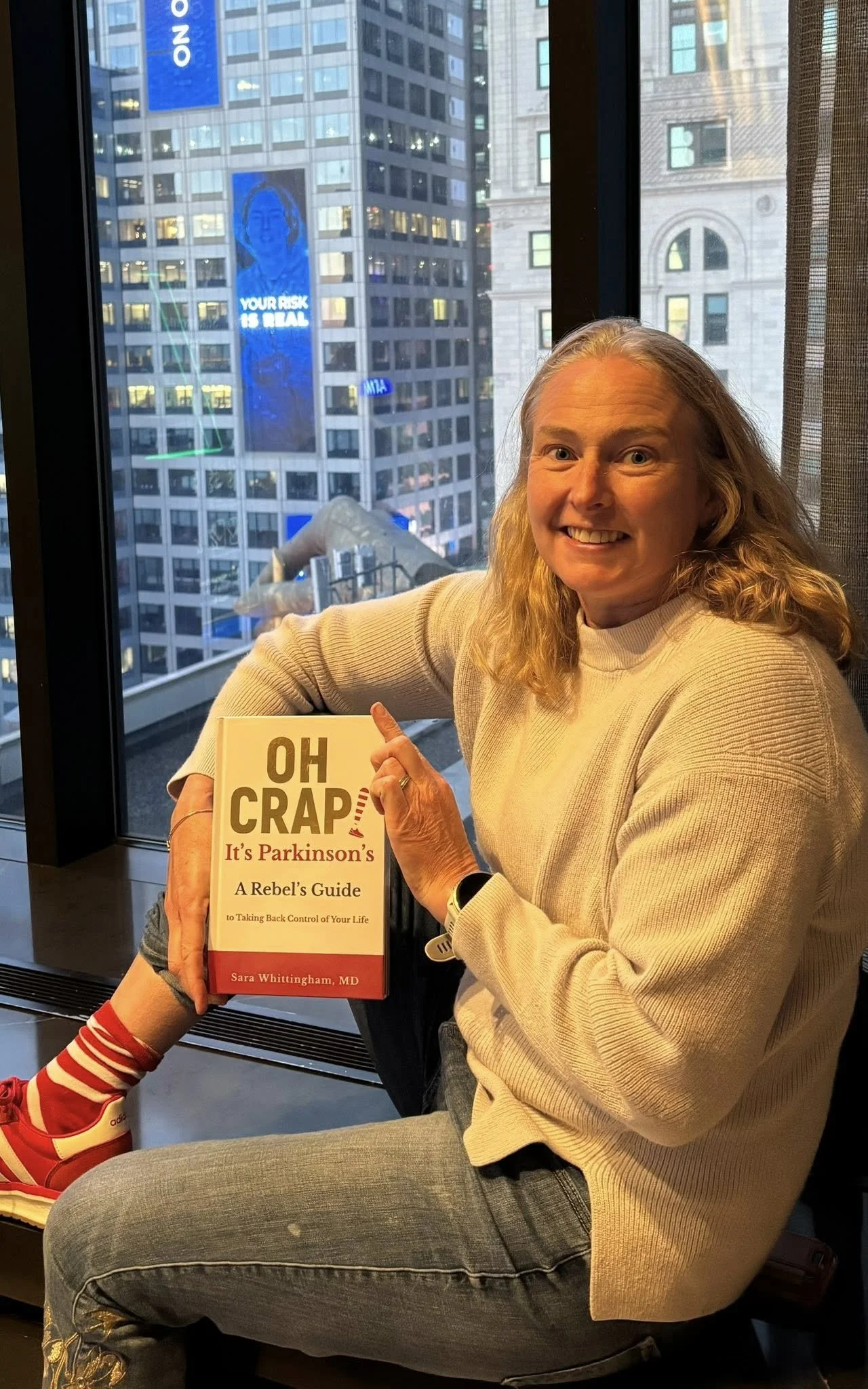 Oh Crap! It's Parkinson's author Sara Whittingham, MD with the @PDAvengers and @PMDAlliance billboard in Times Square.