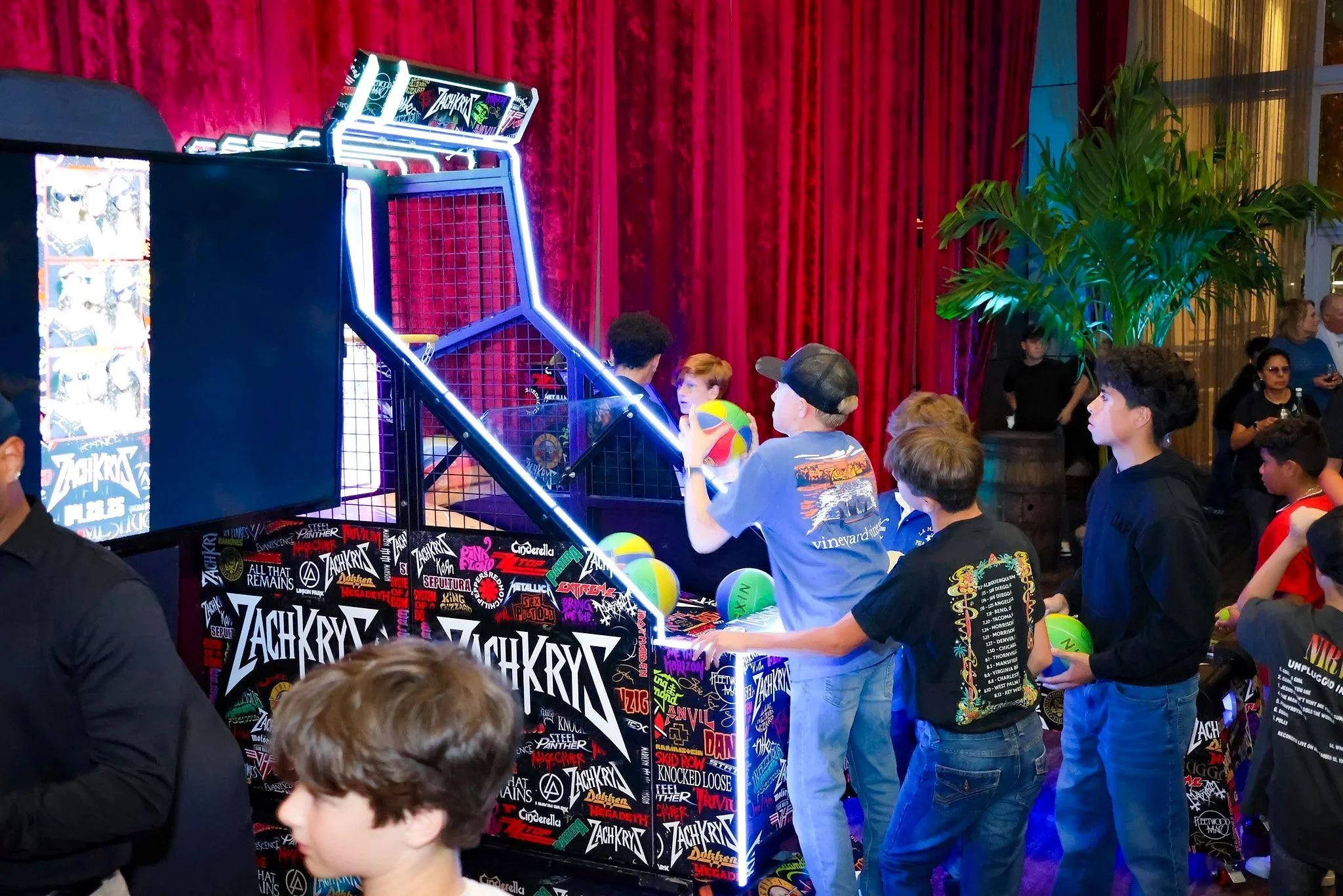 Guest gather to play the Alley Hoops branded basketball machine at a Bar Mitzvah