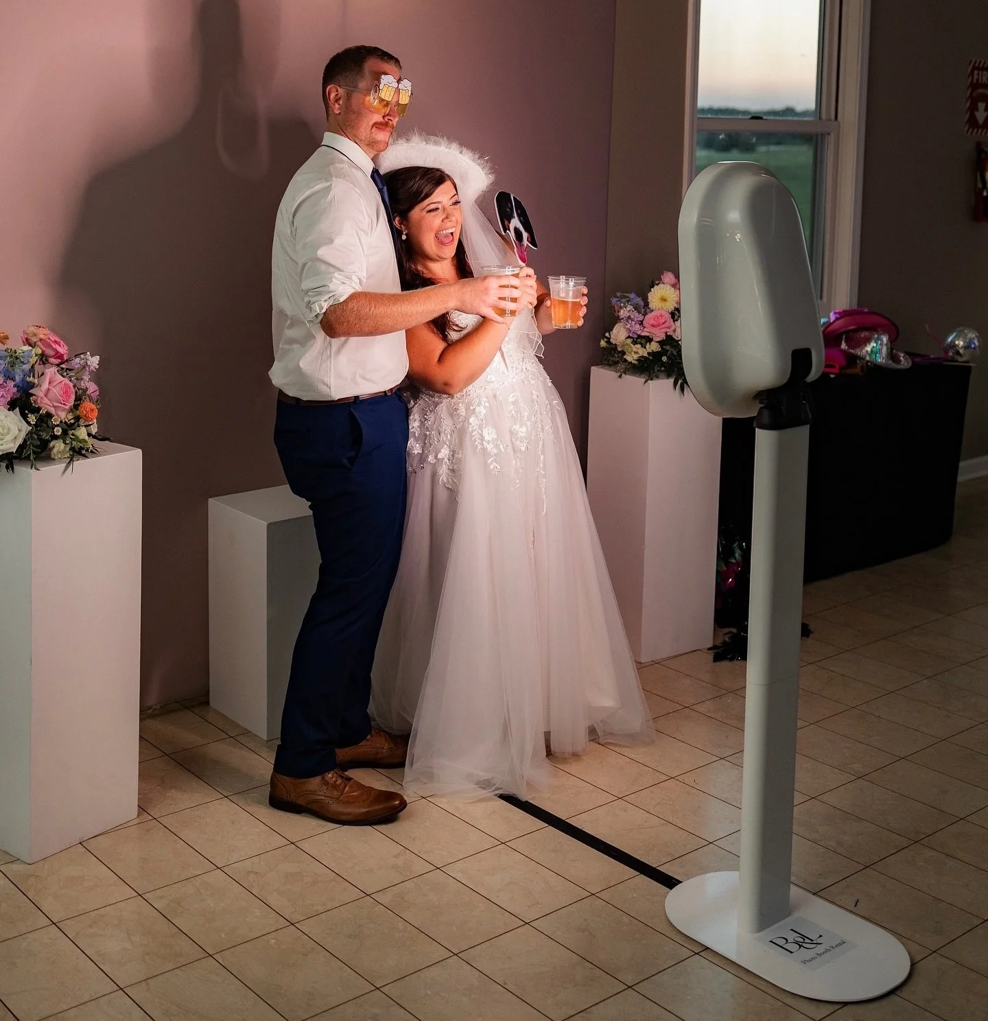 @kathrynschneiderphotography always gets the best behind the scenes shots ✨ This could be you and your guests at your next event! We love how dressed up the photo booth area was with the florals on pedestals too, we always strive to customize the pho