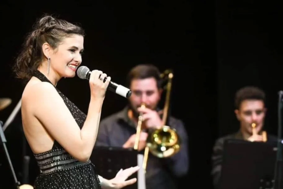 Isabella singing with microphone in hand