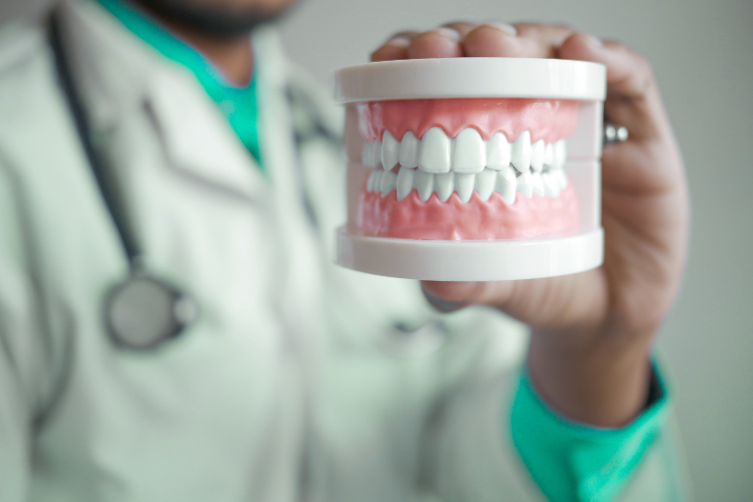 dentist holding dentures