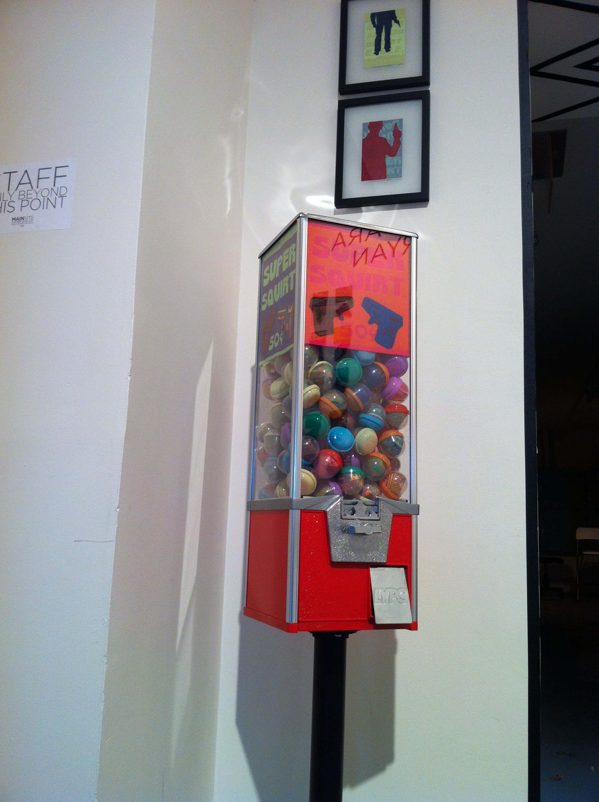 Super Squirt - Print Installation | 2013 | linocut on felt, in plastic dispenser balls, vending machine | prints 3.5"x 3"