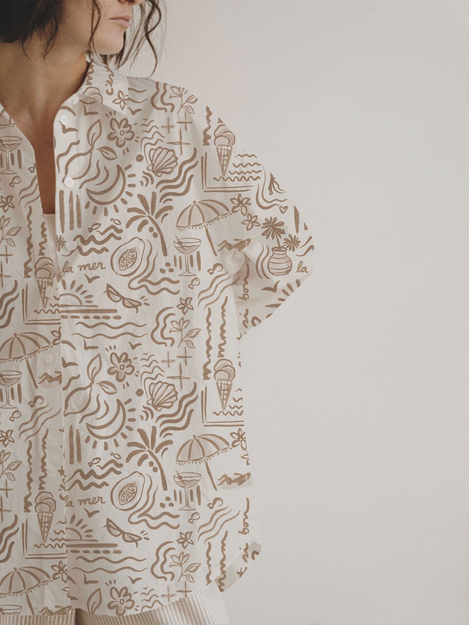 Tropical boho wallpaper pattern with hand-drawn beach symbols in warm earthy tones.