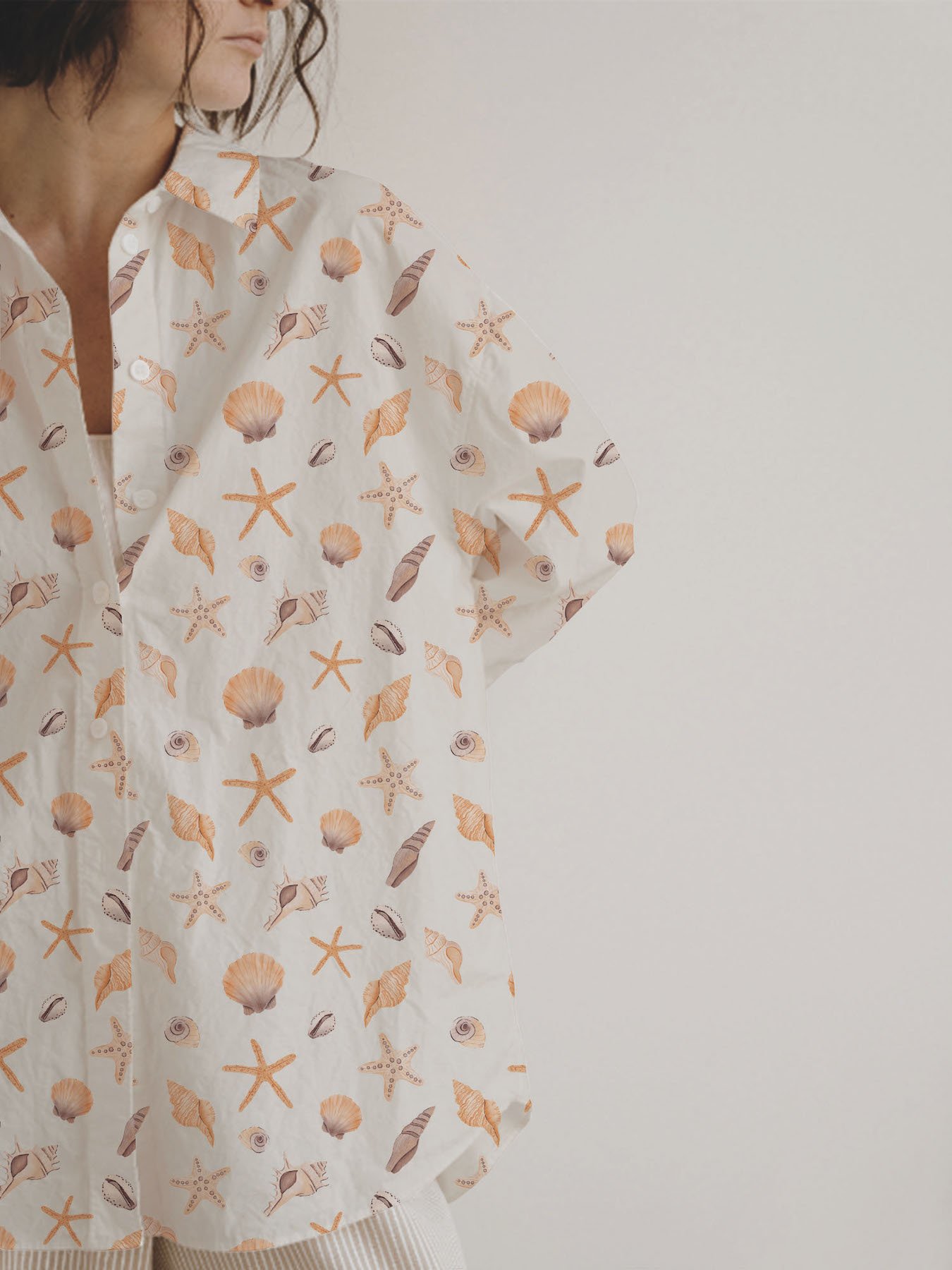 Elegant nautical seashell pattern in warm mocha mousse and orange hues, designed for high-end fashion textiles, beachwear fabrics, and stylish summer apparel.