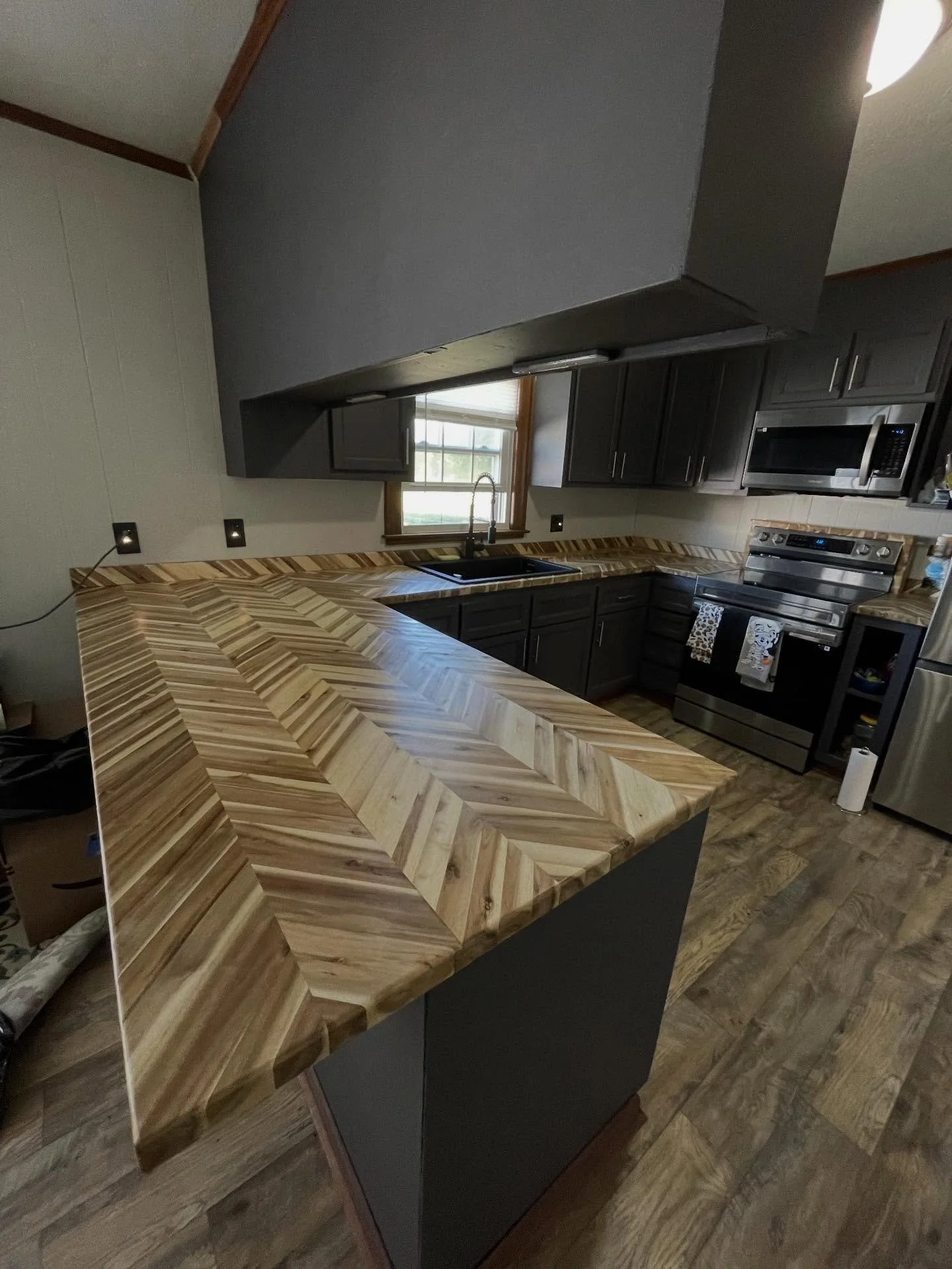Countertop installation. The homeowner wanted this chevron style butcher block installed in their kitchen to replace their old countertops.