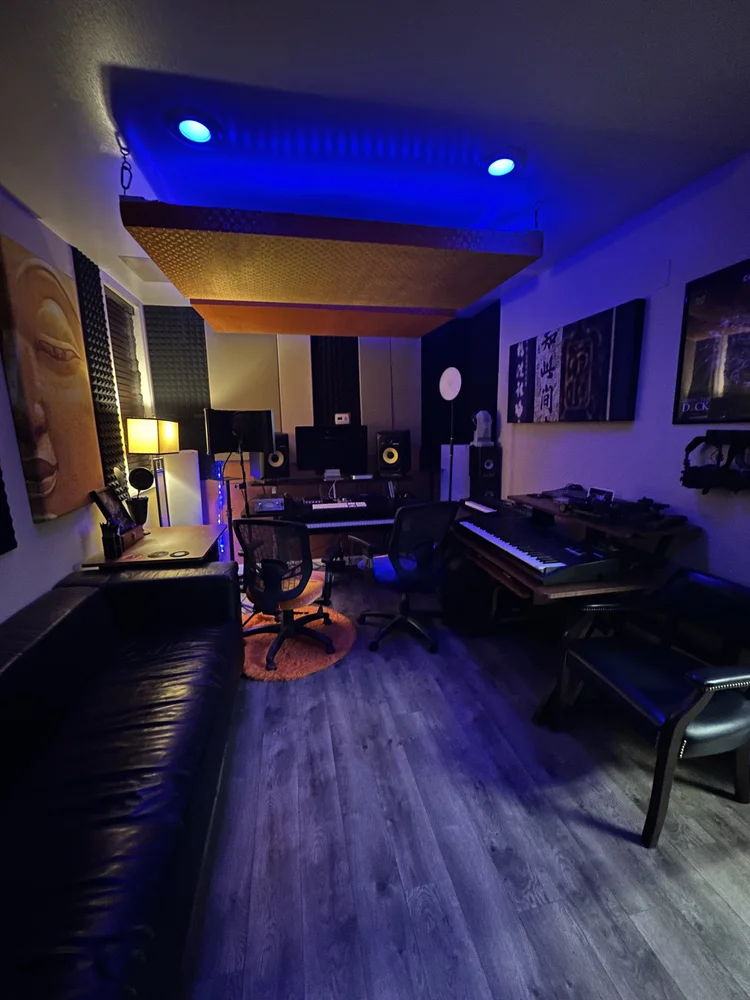 Studio B at The Continental Studios: keyboard workstation, monitors and a leather sofa under blue light