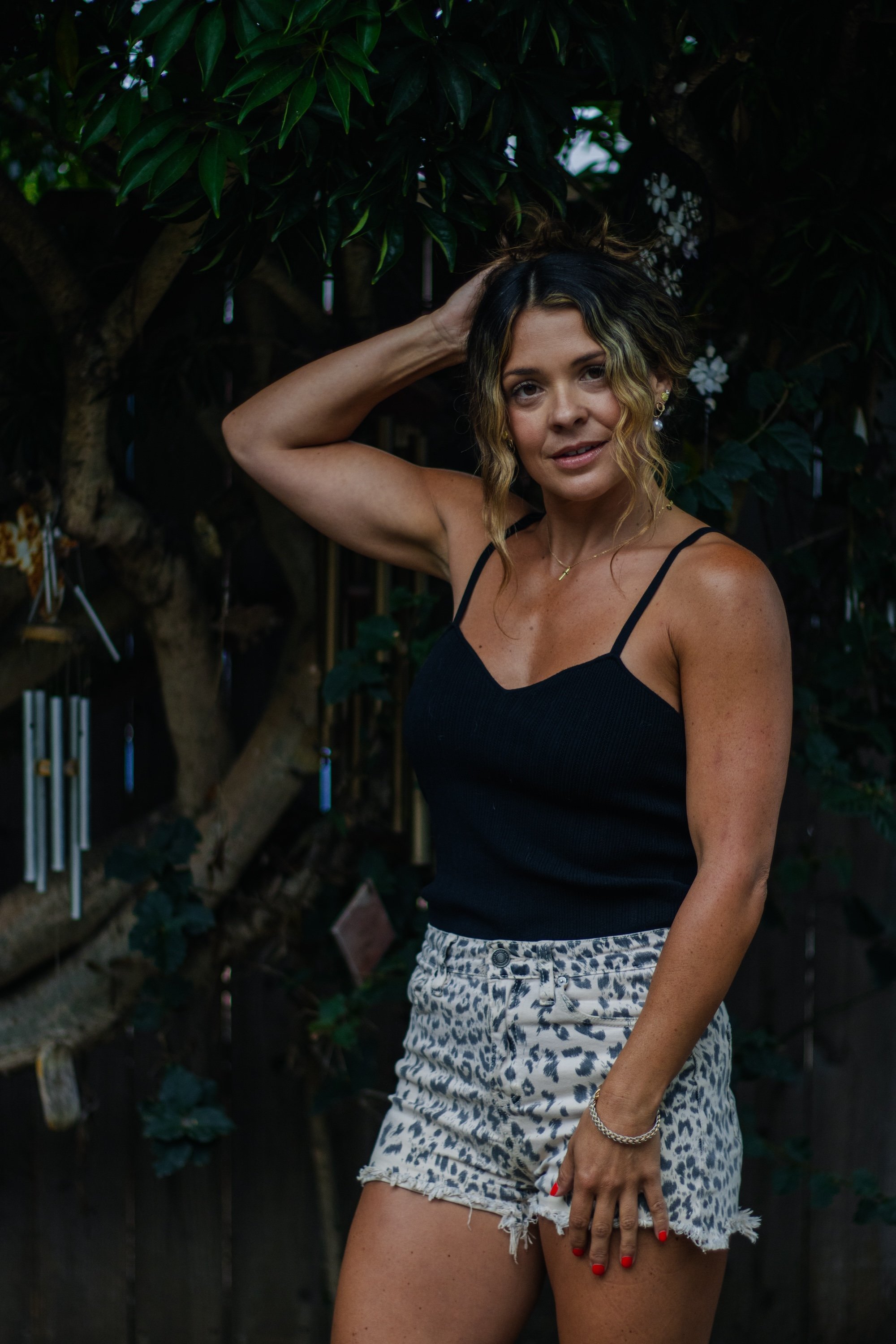 woman standing under a tree in leopard shorts.jpg