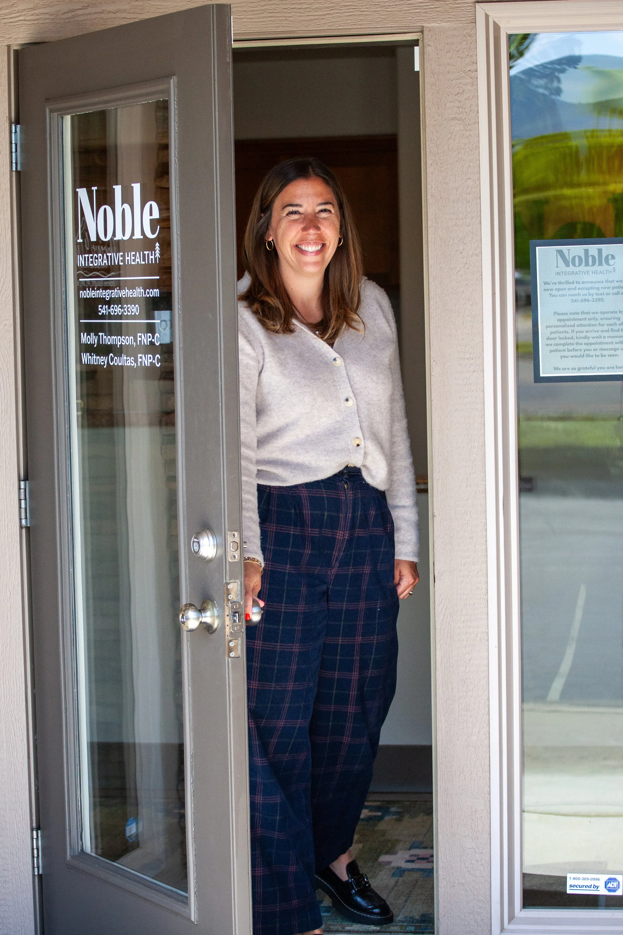Molly Thompson in the doorway of Noble Integrative Health.jpg