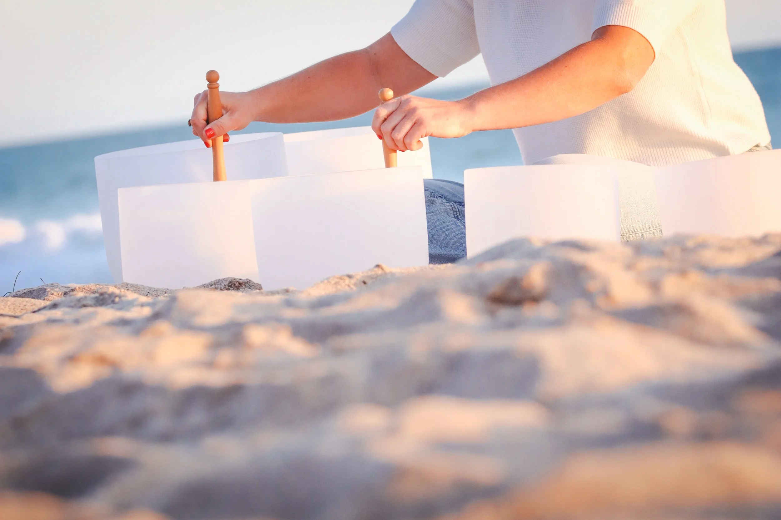 Playing sound bowls at sunset at the beach.jpg